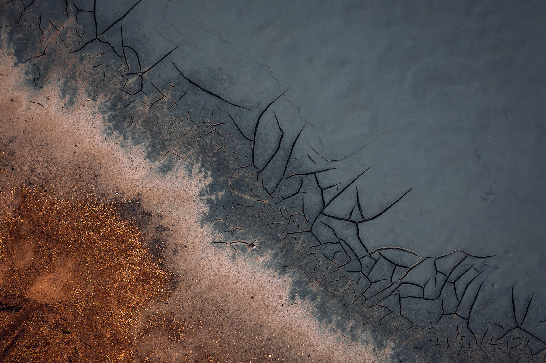Aerial view of abstract mud cracks and sand in Námafjall, Iceland