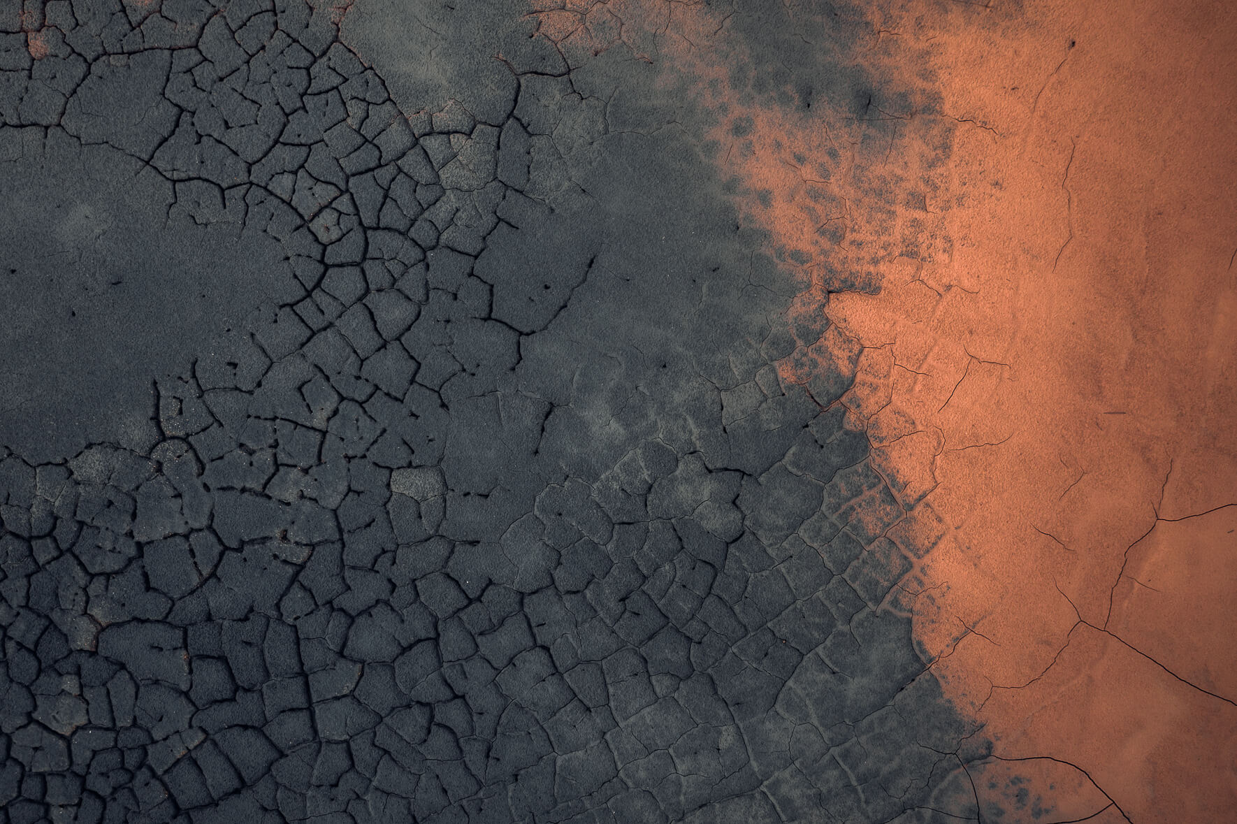 Abstract patterns formed by dried mud cracks in Námafjall, Iceland
