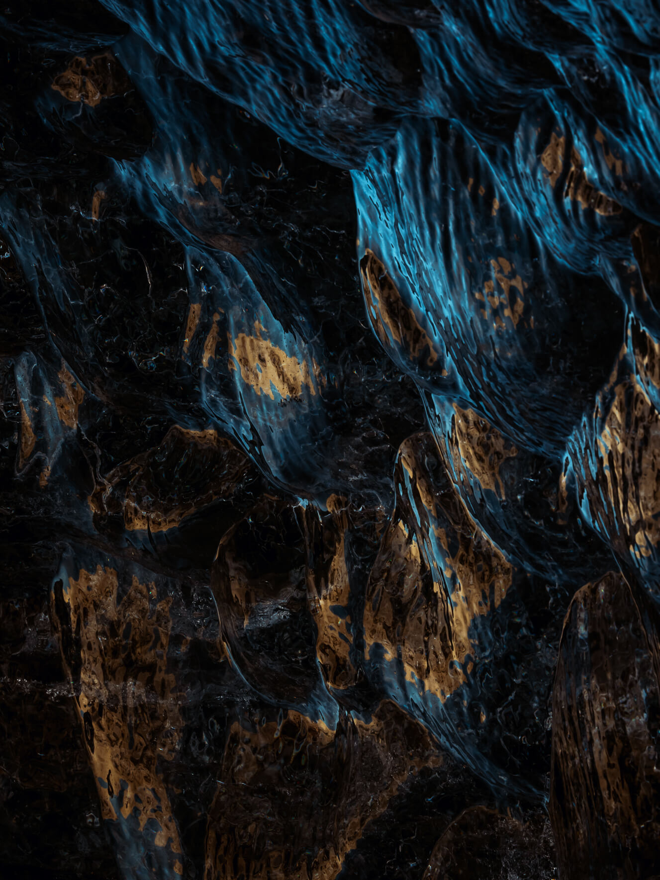 Sunlight reflecting on dark blue glacier ice of Breiðamerkurjökull glacier in Iceland