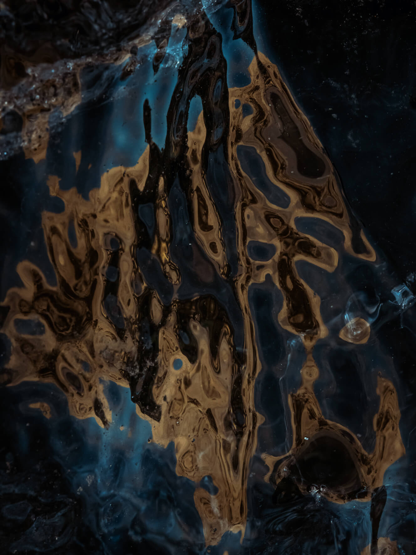 Abstract detail of sunlight reflecting on the dark glacial ice of Vatnajökull glacier in Iceland