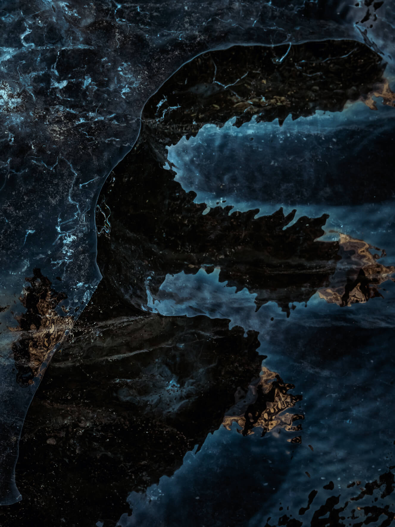 Abstract reflections on dark glacier ice of Breiðamerkurjökull glacier (Vatnajökull) in Iceland