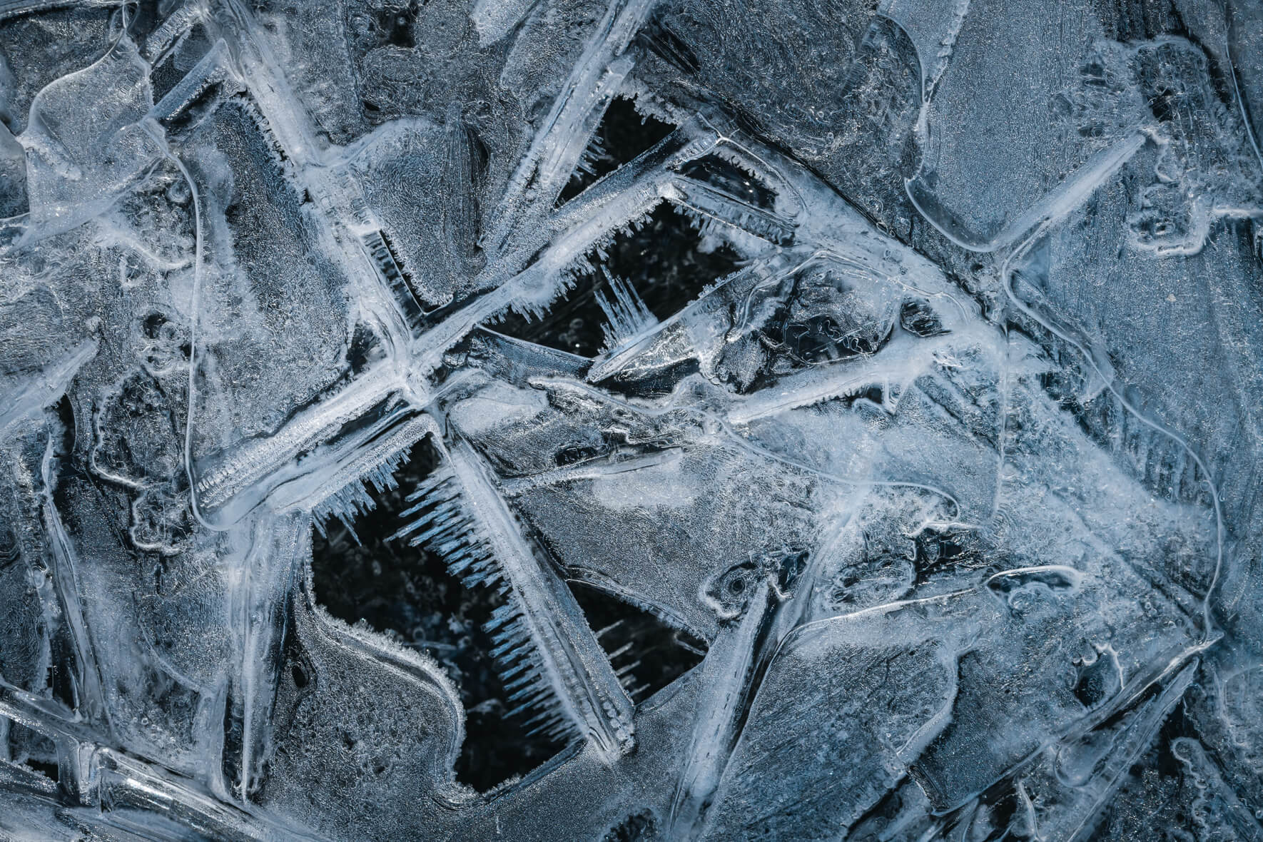 Macro shot with abstract details of ice of a frozen creek