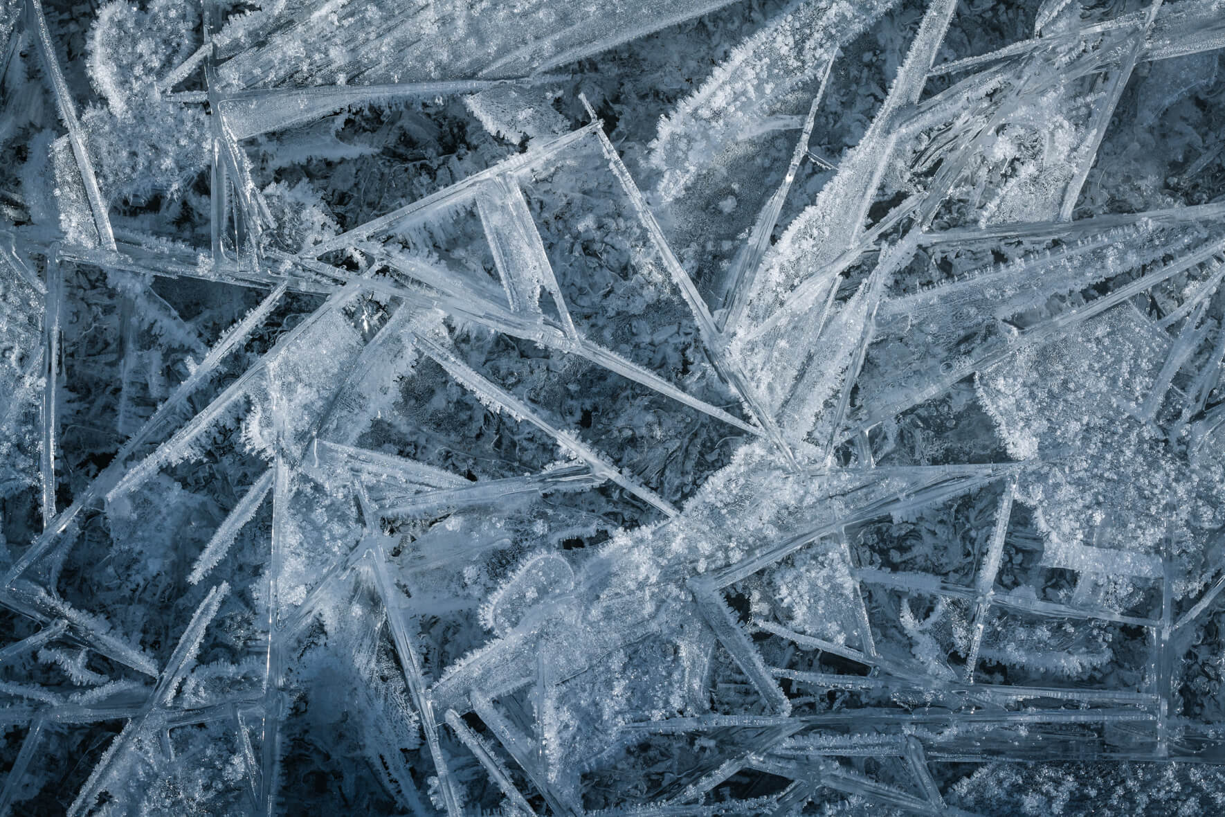 Macro photography of abstract ice crystals on a frozen stream