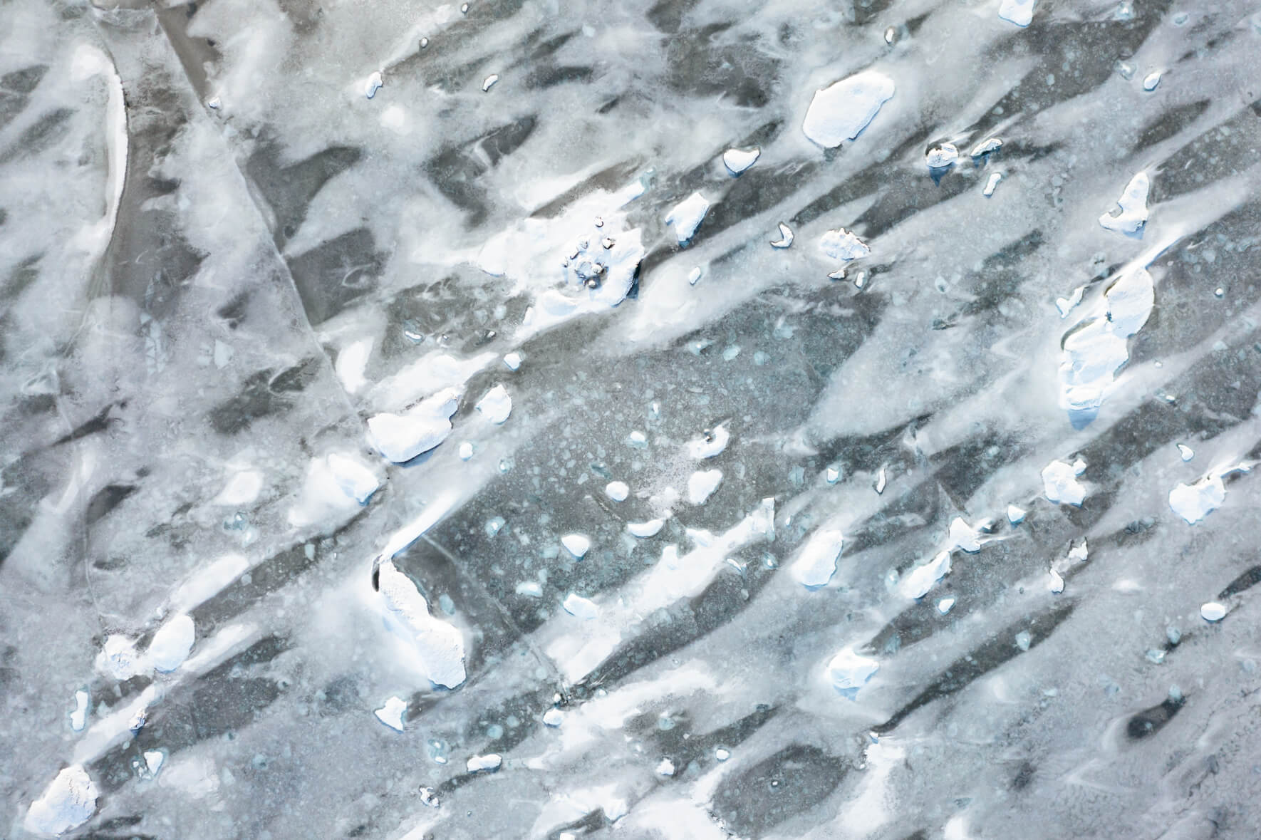 Aerial view of frozen lake and glacier lagoon Jökulsárlón in Iceland with abstract patterns on the surface