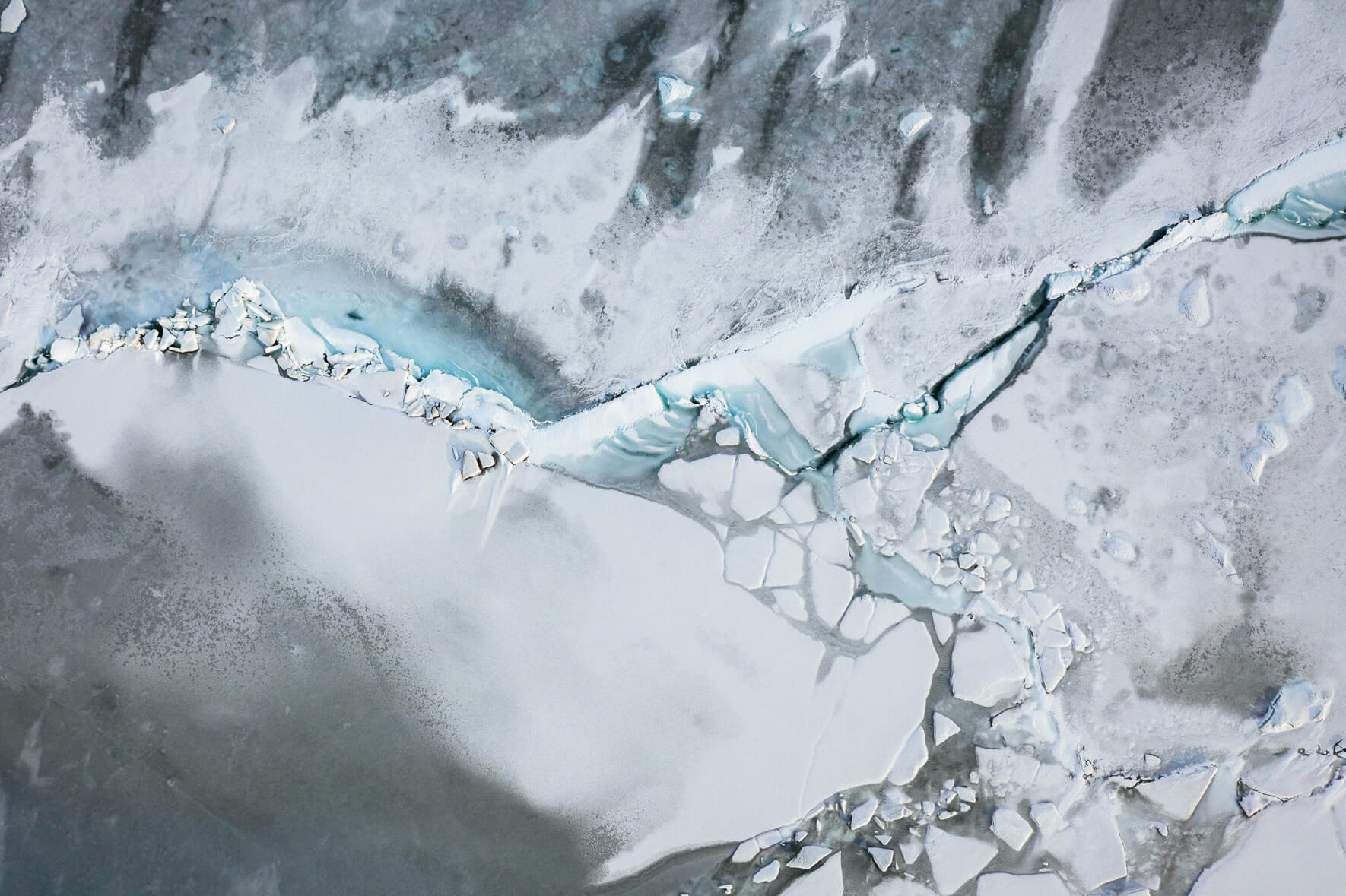 Aerial view of frozen glacier lagoon Jökulsárlón in Iceland with ice floes and abstract patterns on the surface