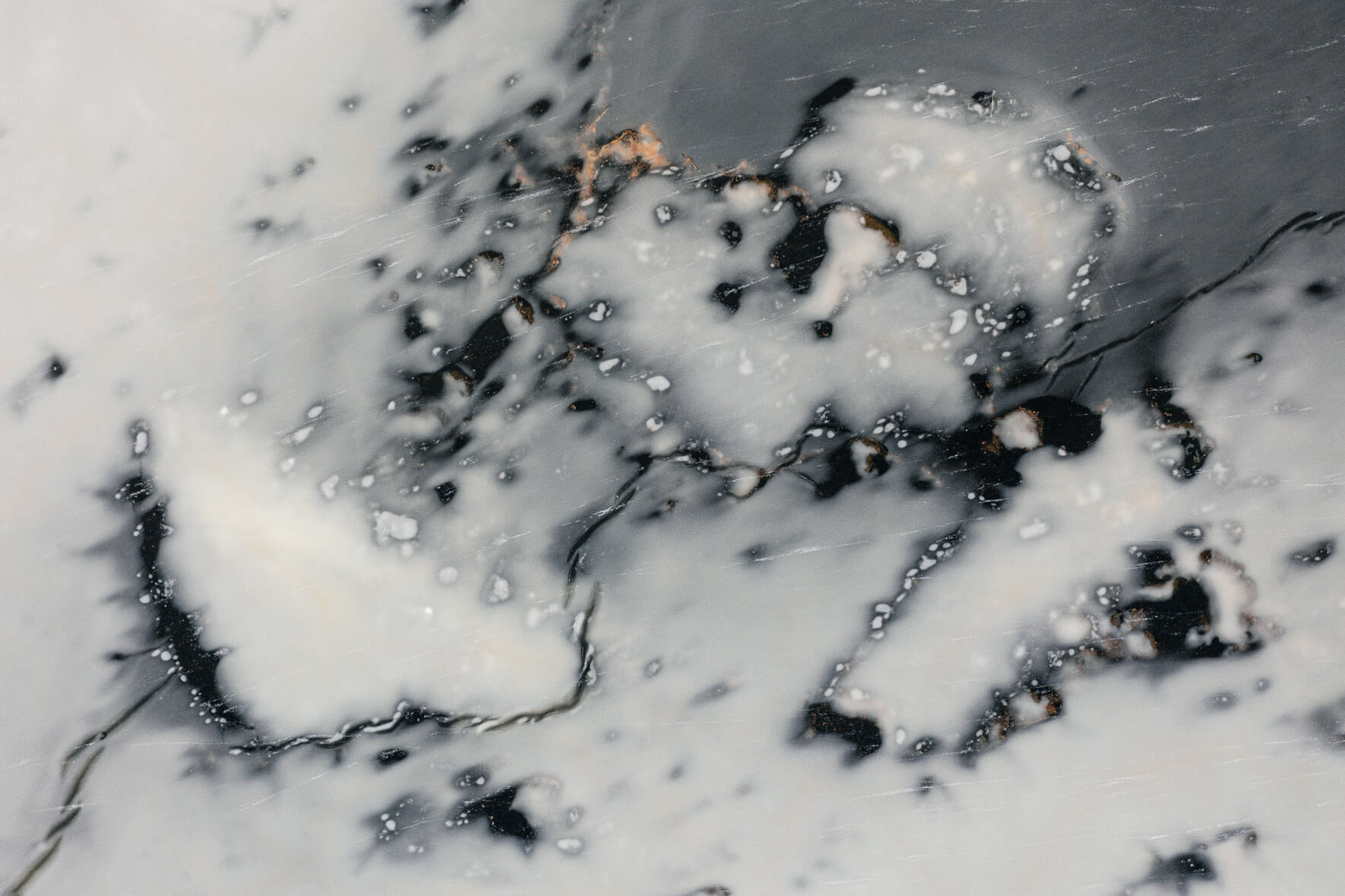 Aerial view of a frozen lake in Norway with abstract patterns on the ice surface