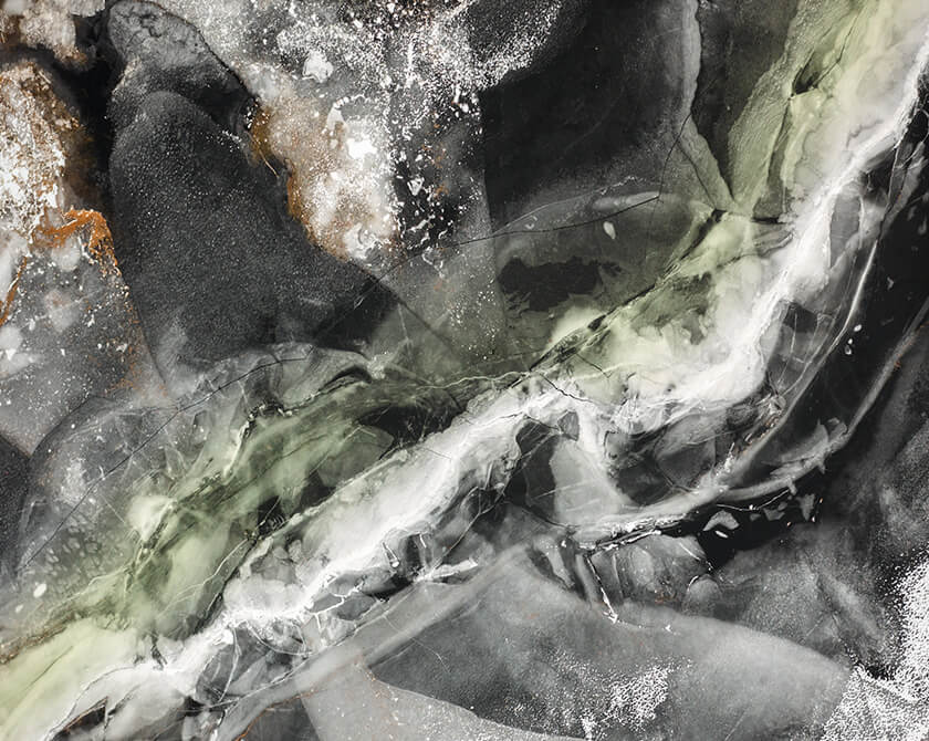 Aerial view of frozen lake in Norway with abstract textures on the ice surface and water channels