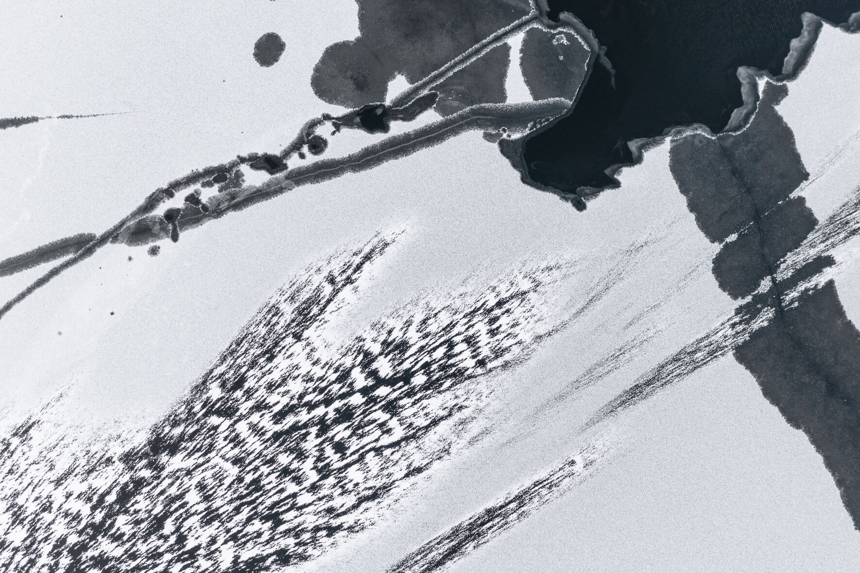 Abstract aerial view of a frozen lake in Norway with windblown snow