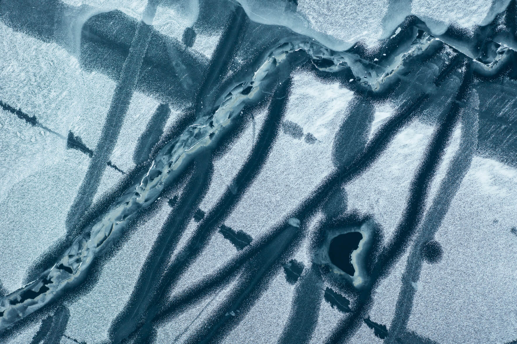 Chaotic patterns and cracks on frozen lake Åraksfjorden  in Norway during thawing weather