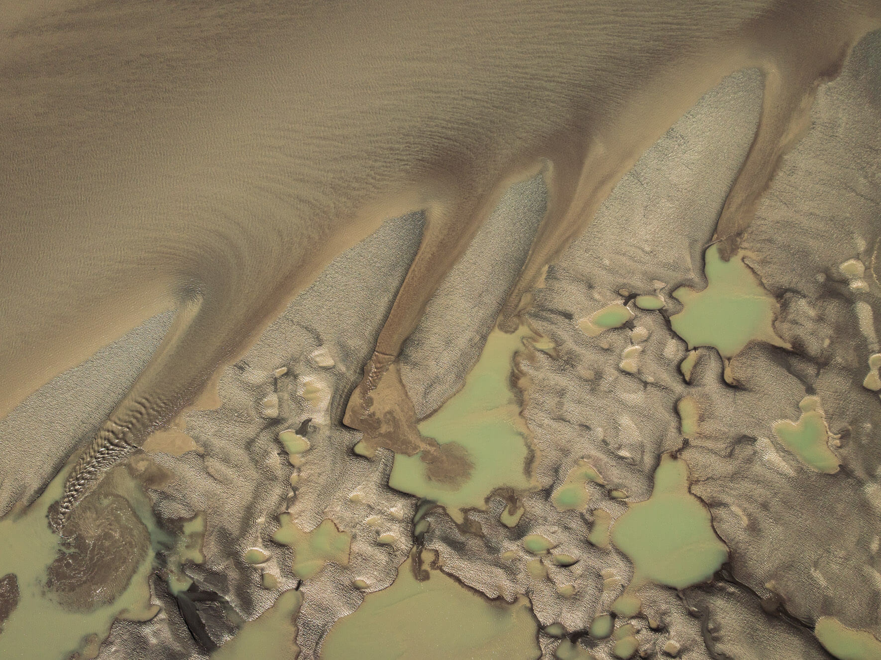 Scattered tidal pools in Alaska during low-tide