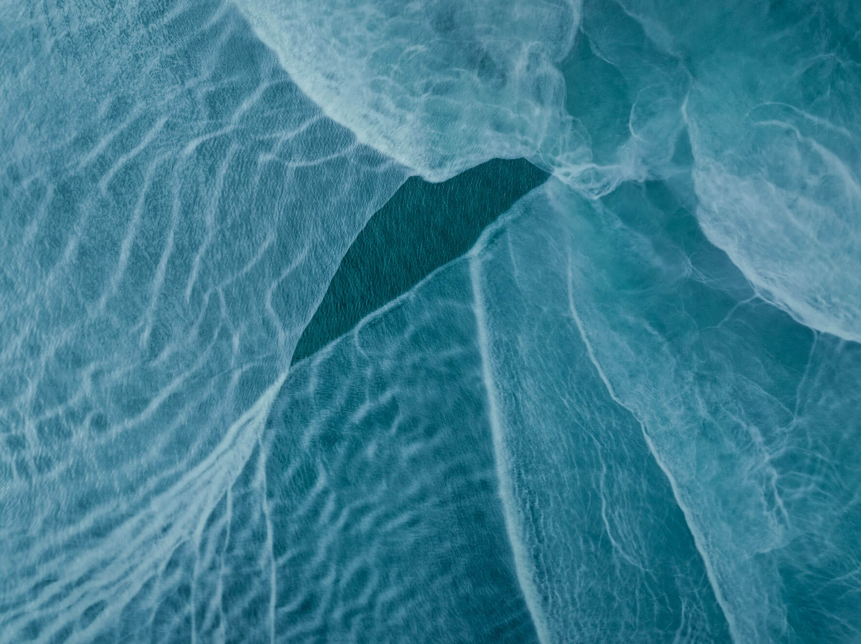 Aerial view of turquoise waters in Alaska, shaped by glacial silt and minerals