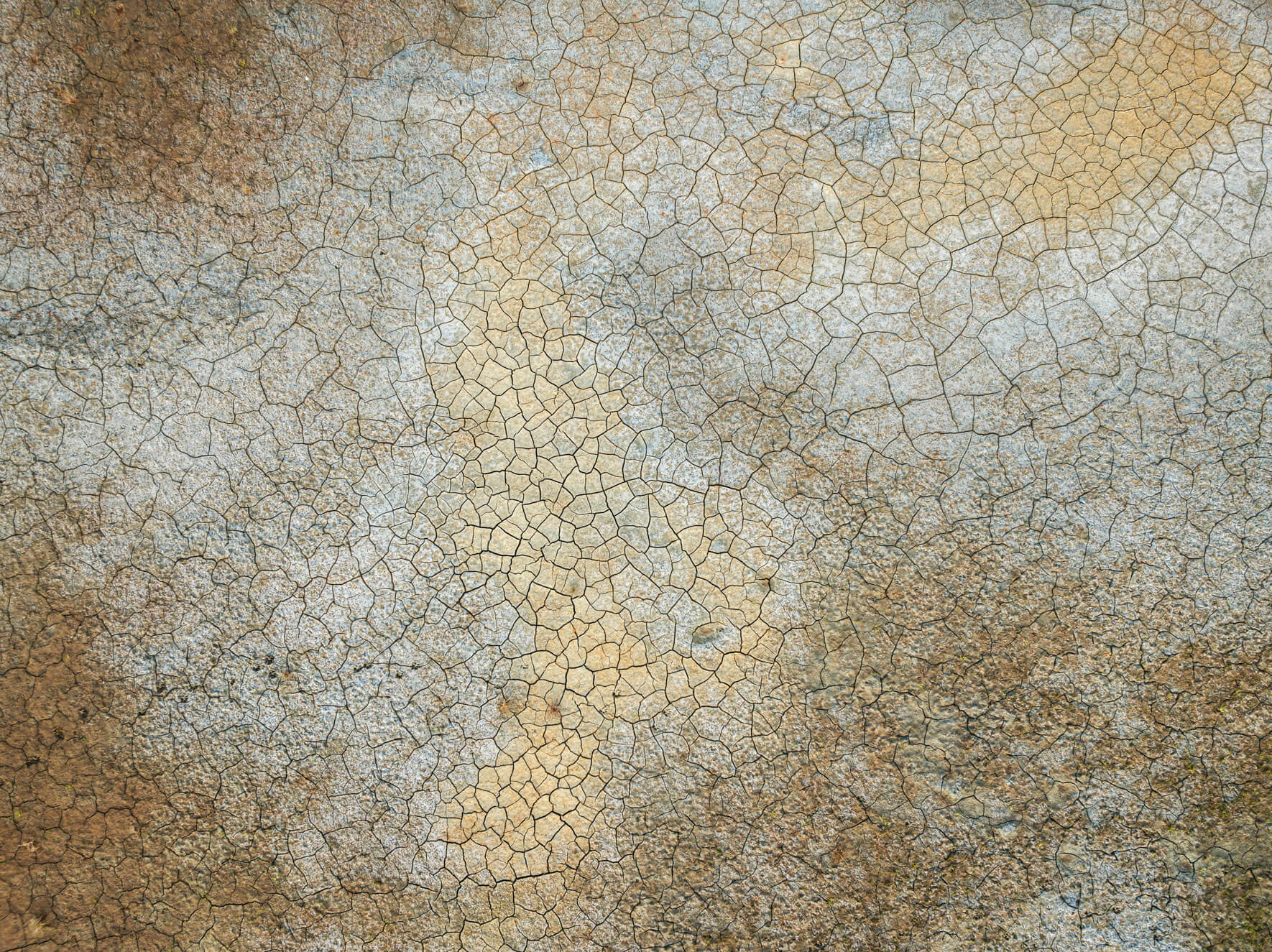 Aerial view of cracked earth textures in Alaska’s intertidal zone