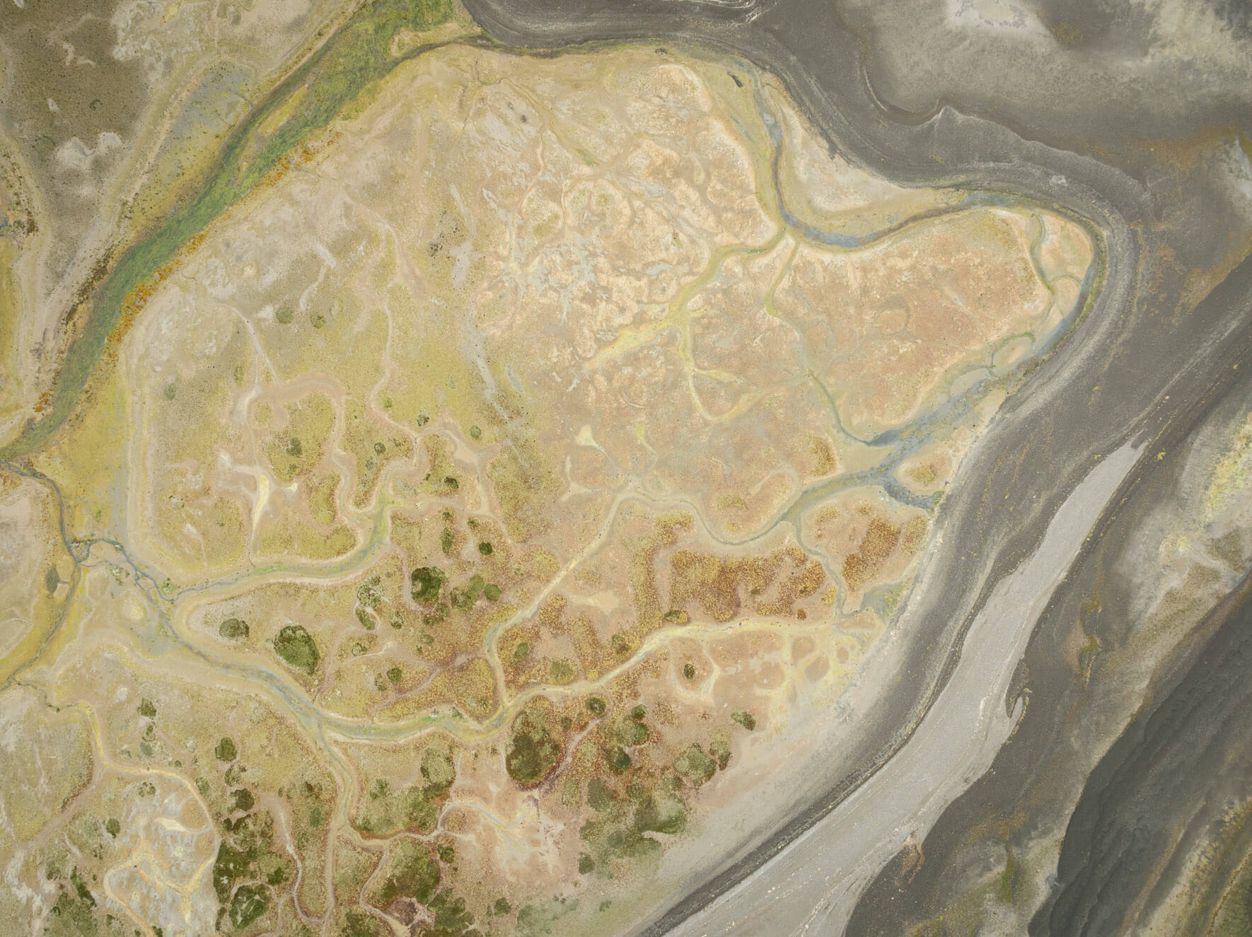 Abstract aerial composition of Alaska’s intertidal landscapes, shaped by tidal forces