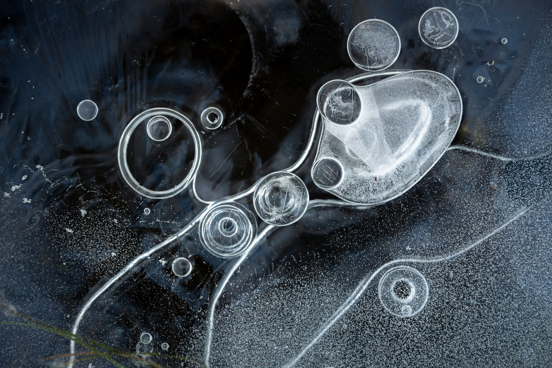 Abstract macro details of a frozen puddle with air bubbles
