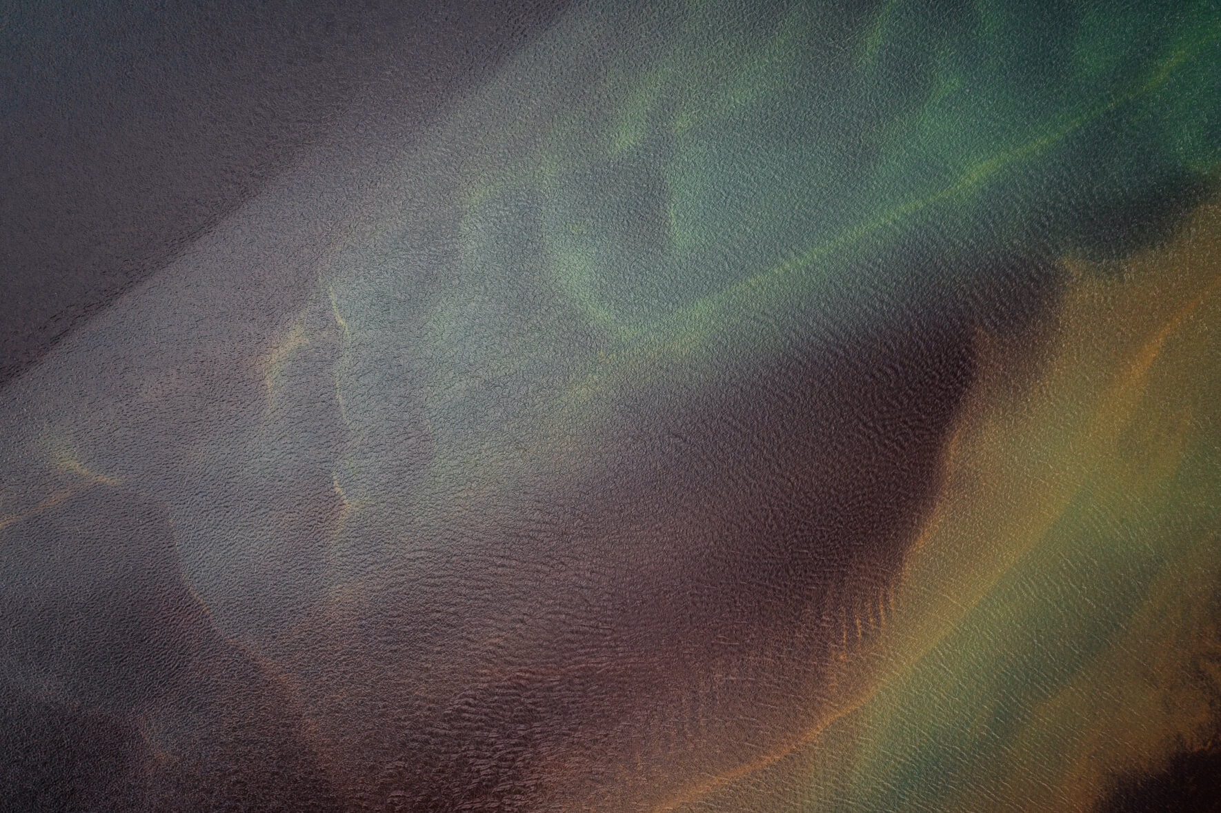 Aerial view of a glacial river in Iceland with abstract patterns in the water