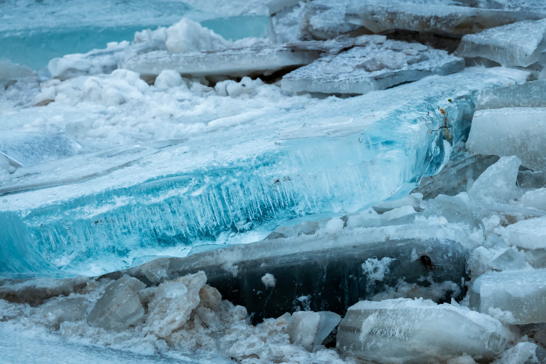 Details of ice floes piled on top of each other on the banks of a river in Iceland