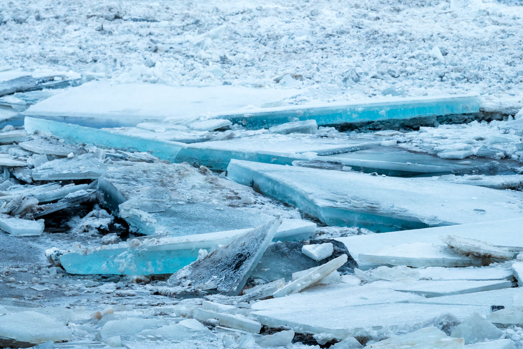 Ice floes piled on top of each other on the banks of a river in Iceland