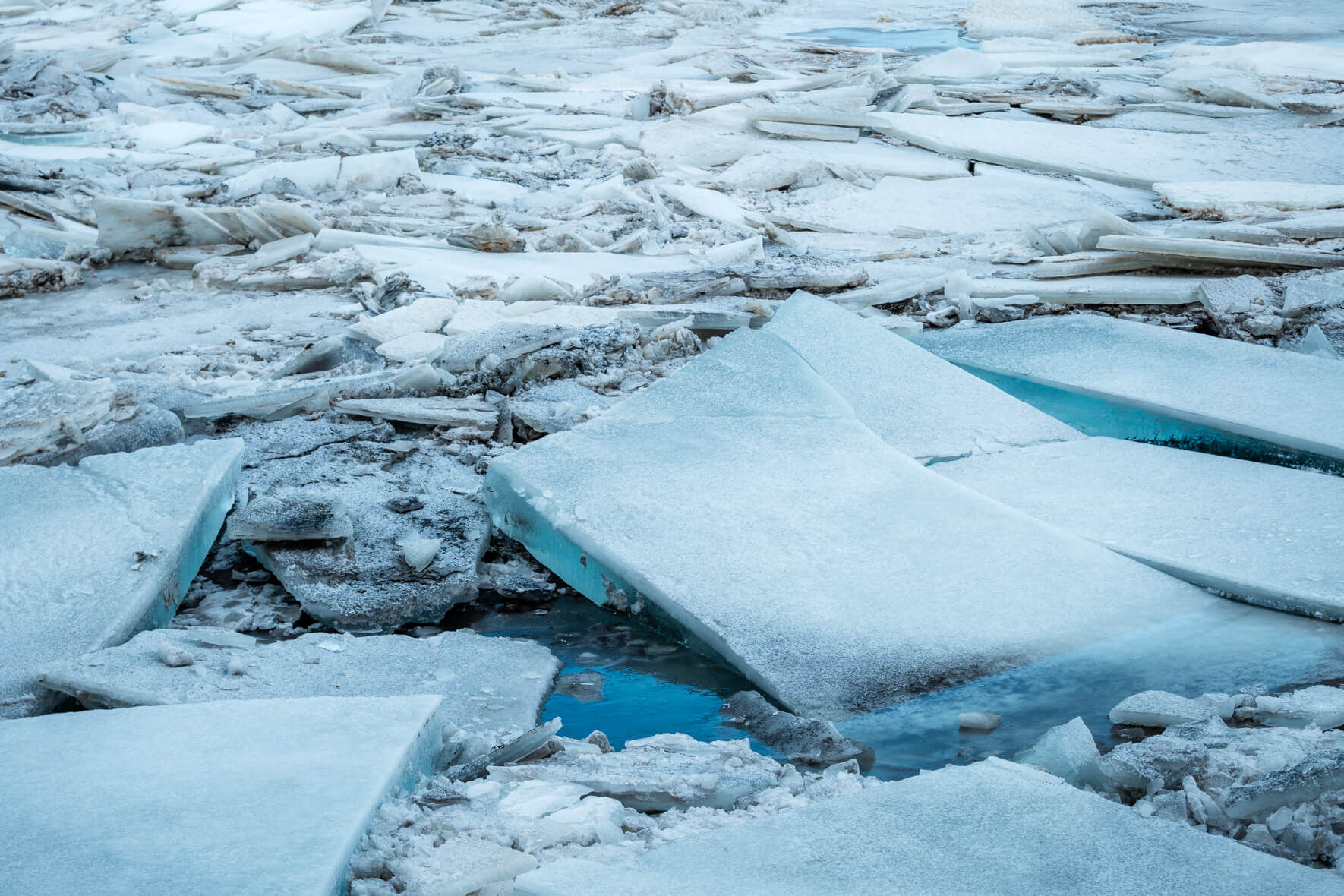 Colorful ice floes piled on top of each other on a river in Iceland