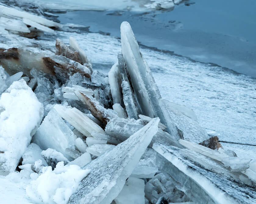 Ice floes stacked on top of each other on the banks of a river in Iceland