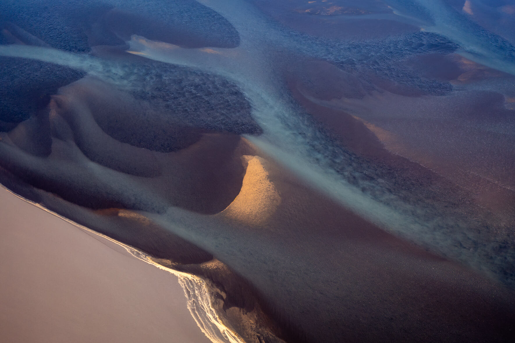 Iceland’s dynamic river systems from above, revealing fluid, ever-changing textures and colors