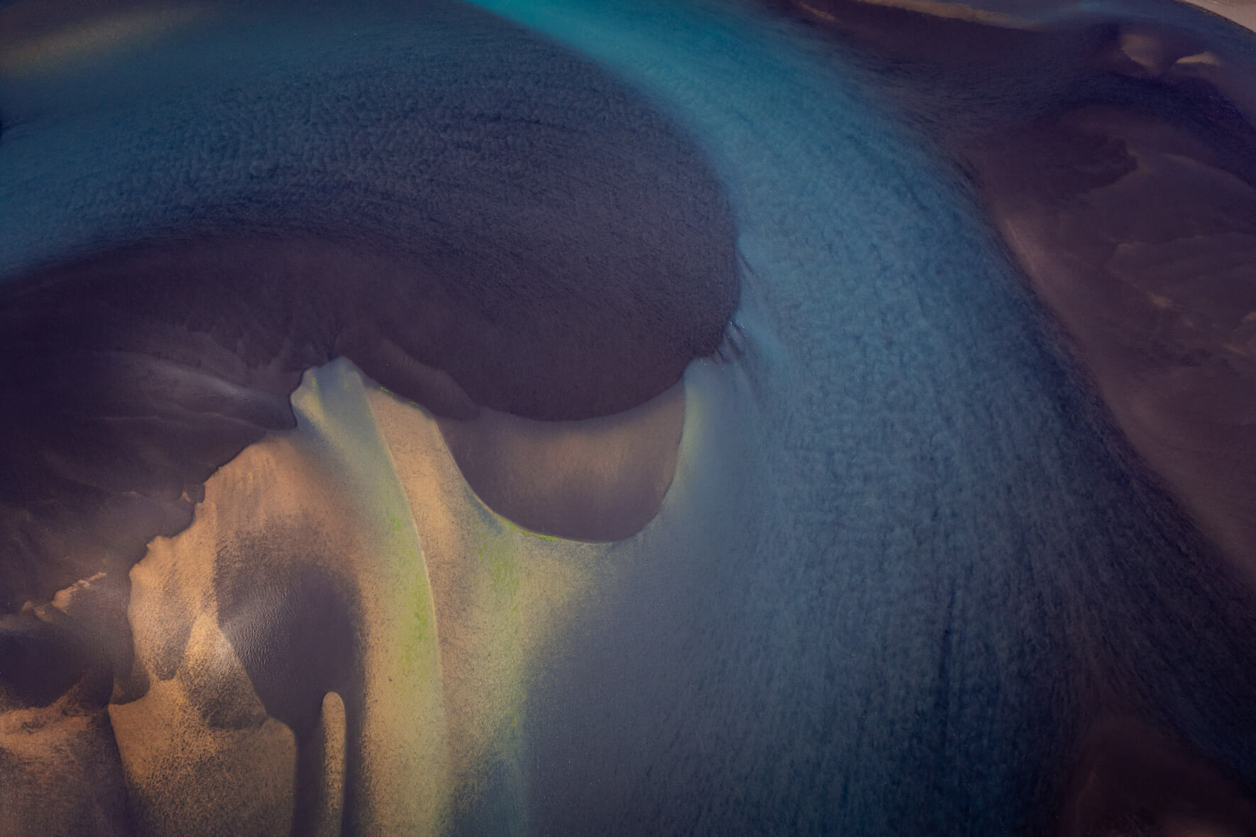 Aerial abstraction of Iceland’s waterways, where flowing currents form organic designs