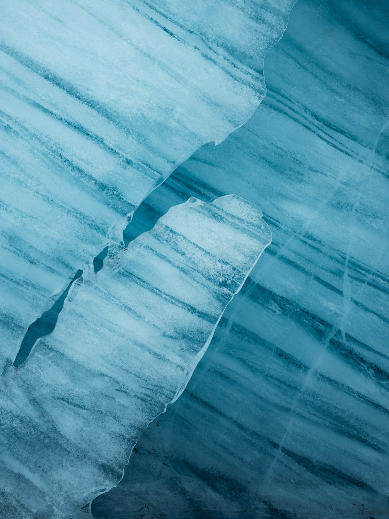 Icelandic ice tunnel with polished walls, reflecting light in mesmerizing blue shades