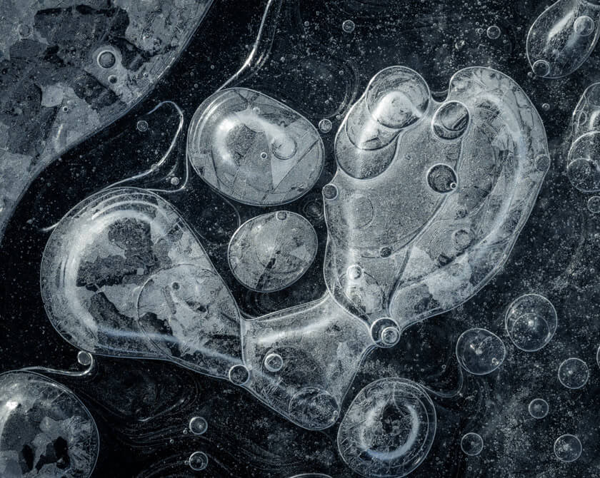 Macro photography of air bubbles trapped in dark glacial ice in Iceland
