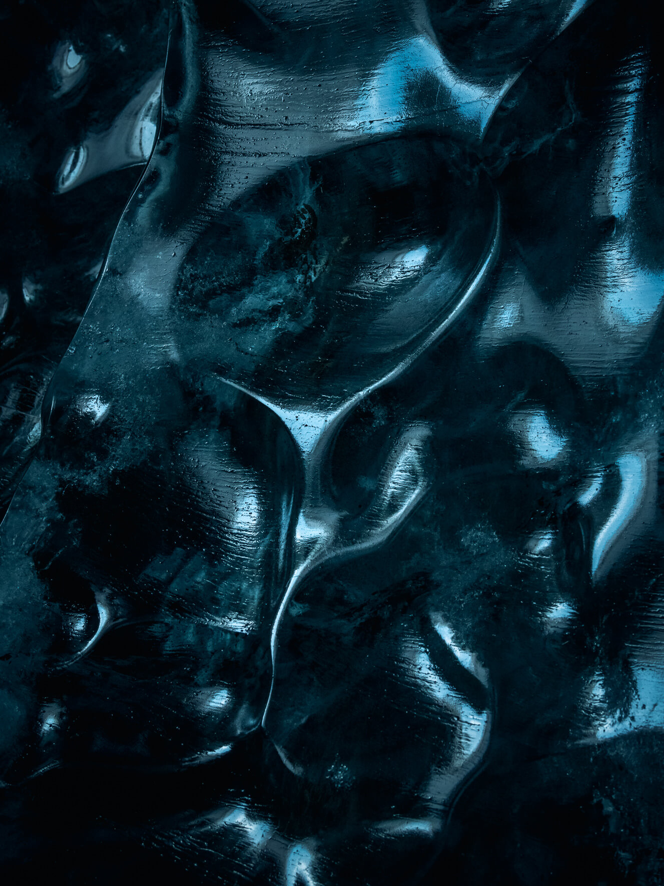 Blue glacier ice with light reflections in Iceland