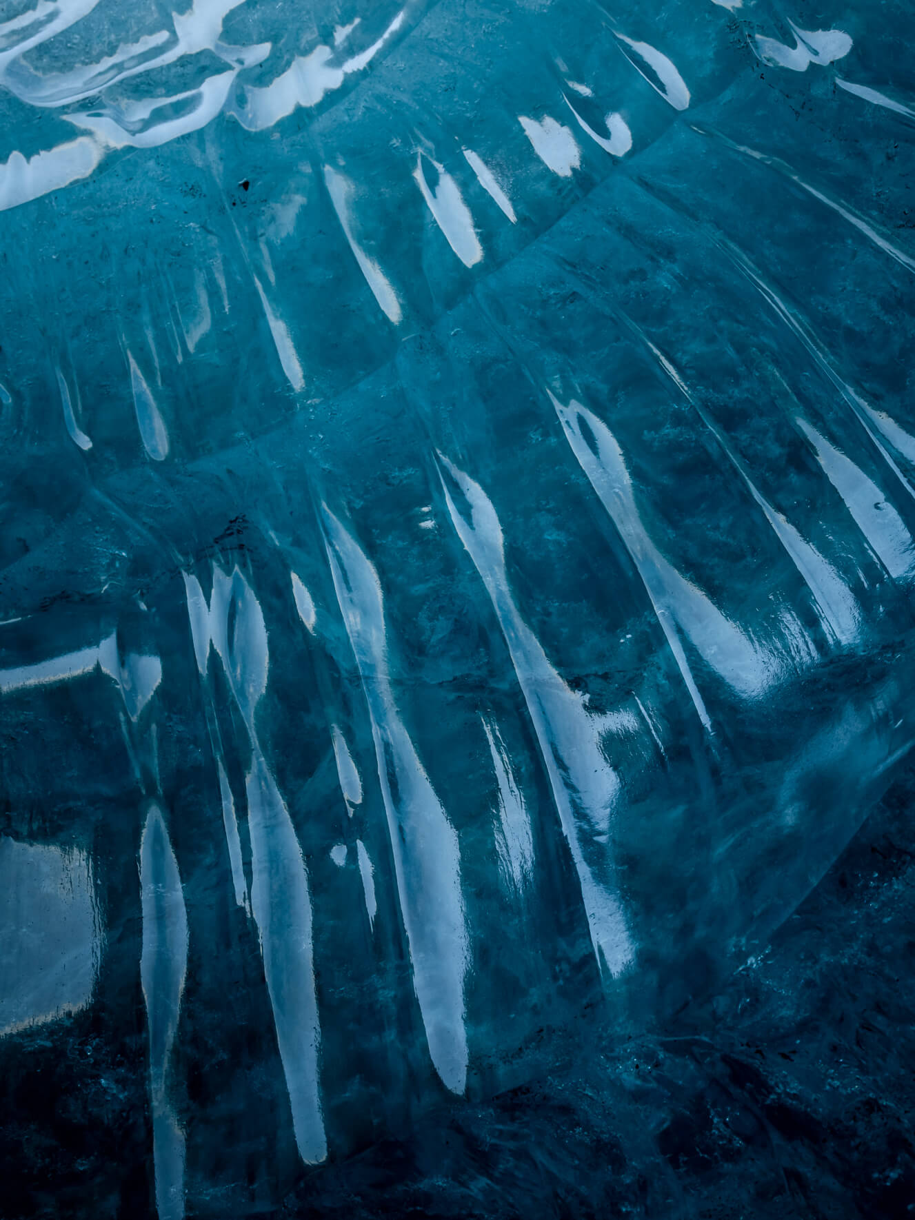 Blue glacier ice of Breiðamerkurjökull in Iceland with abstract patterns