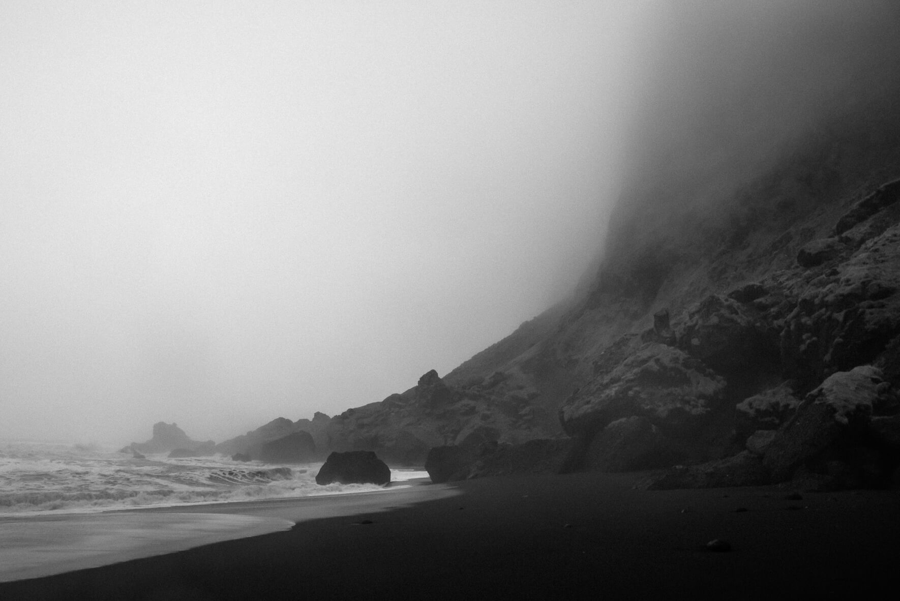 The cliffs on the black sand beach of Vík n Iceland on a foggy day (black & white)