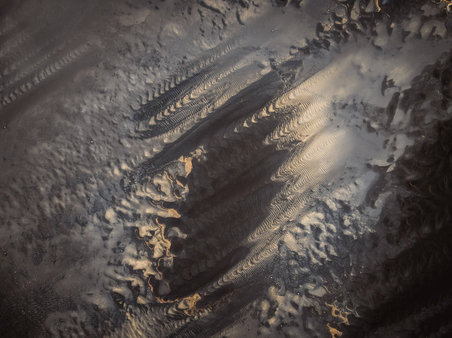 Aerial view of abstract tidal sand patterns in Iceland shaped by receding water