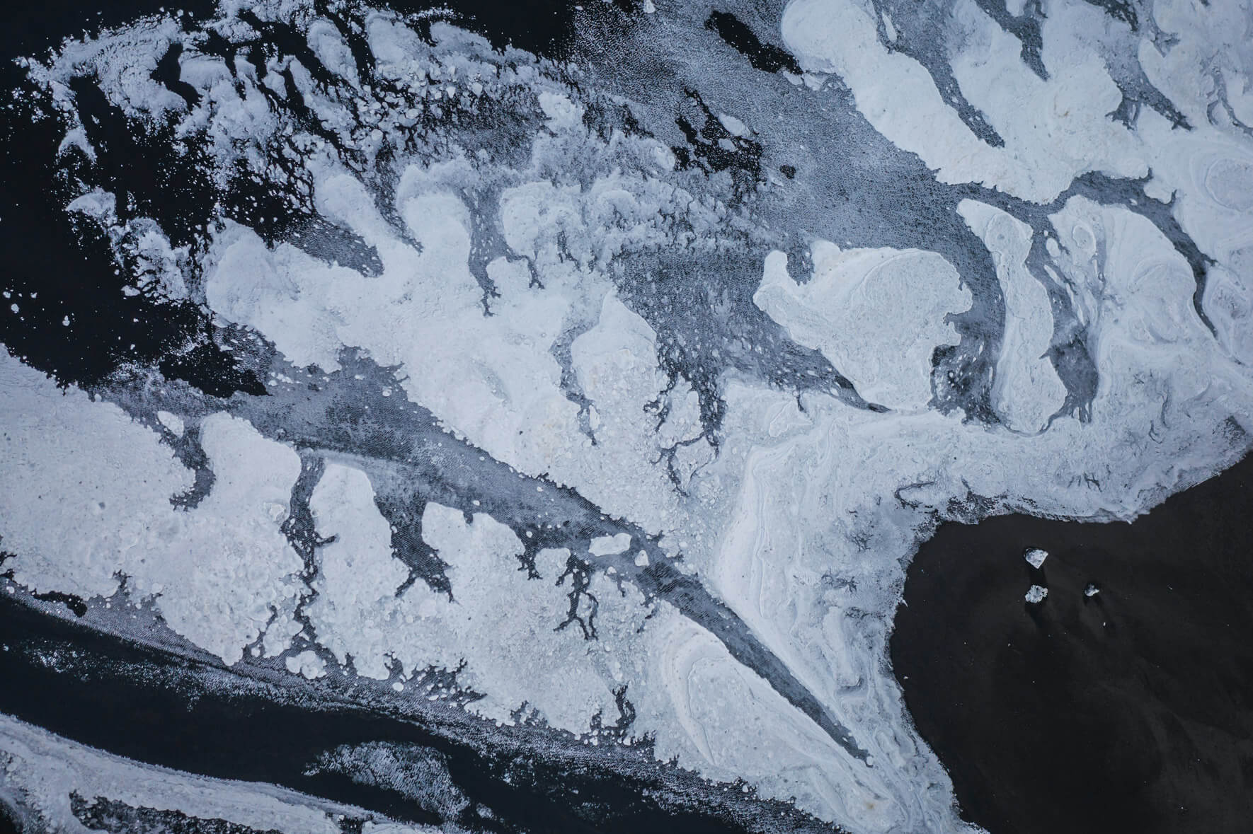 Aerial view of a dried glacier riverbed in Iceland with snow ice in winter