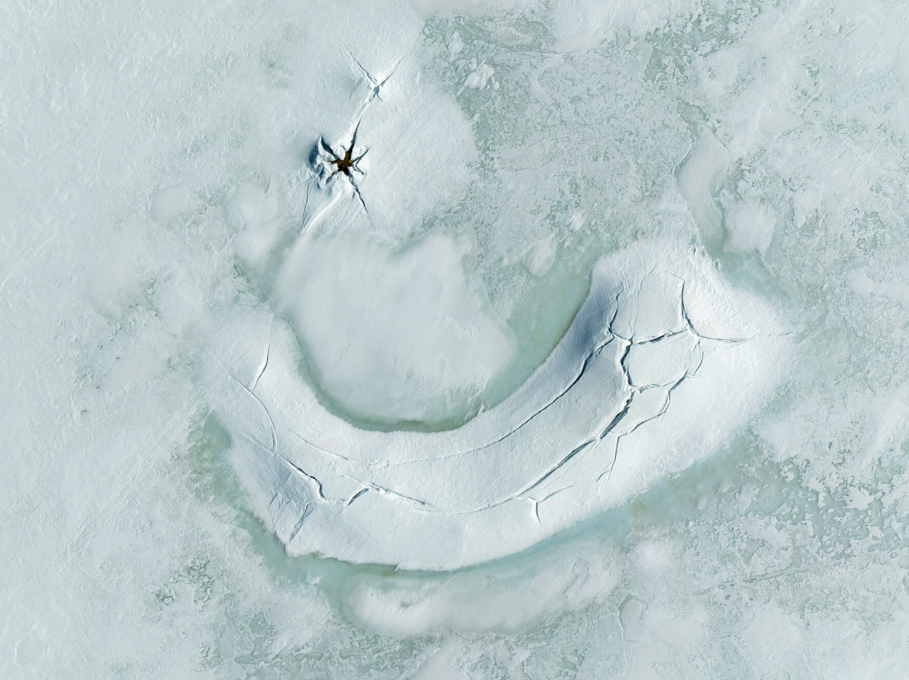 Cracks in the frozen lake surface of Hardangervidda Norway