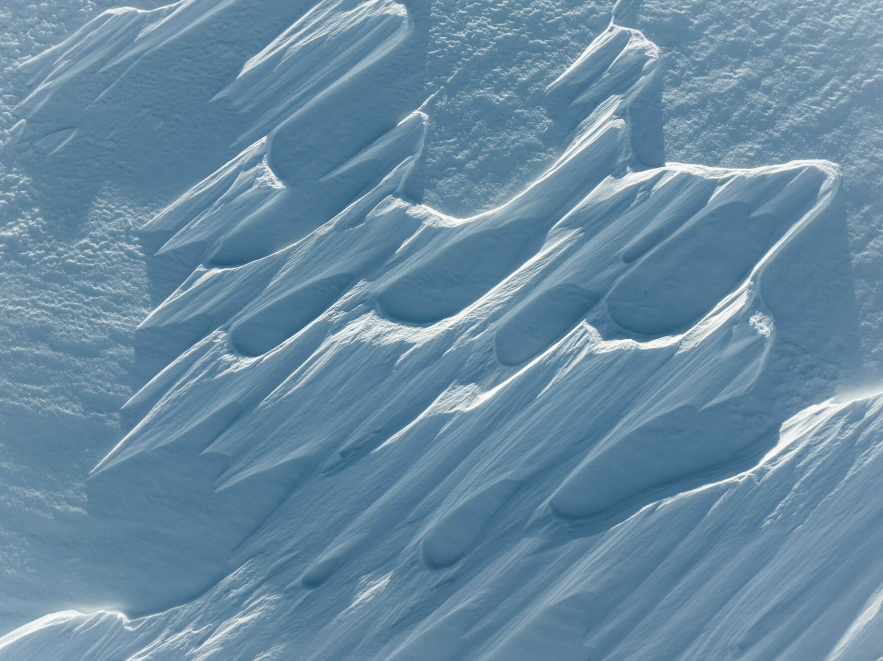 Abstract snow drift patterns shaped by wind in Norway’s Hardangervidda region