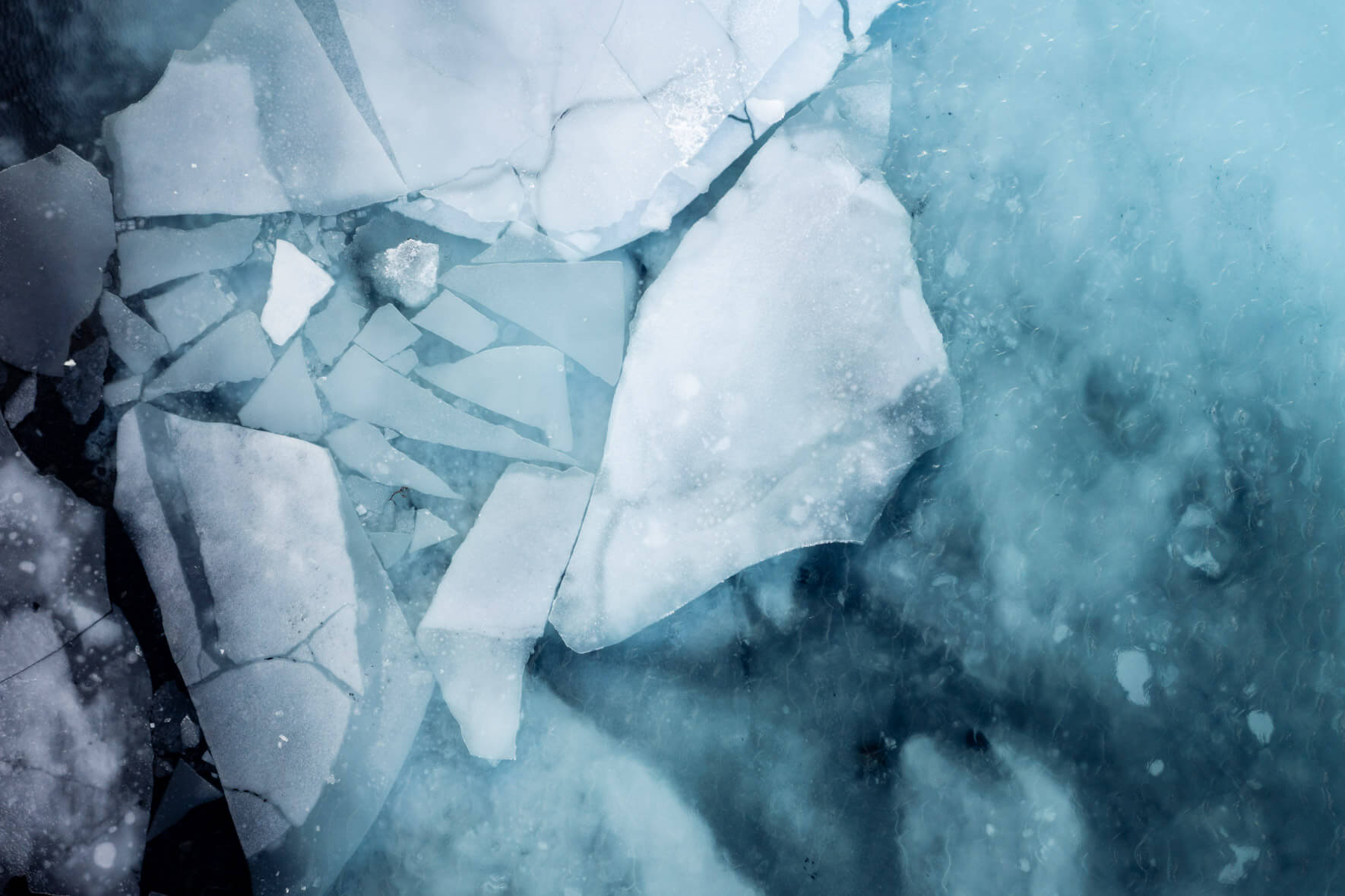 Aerial view of a thawing lake in Iceland with ice on the surface