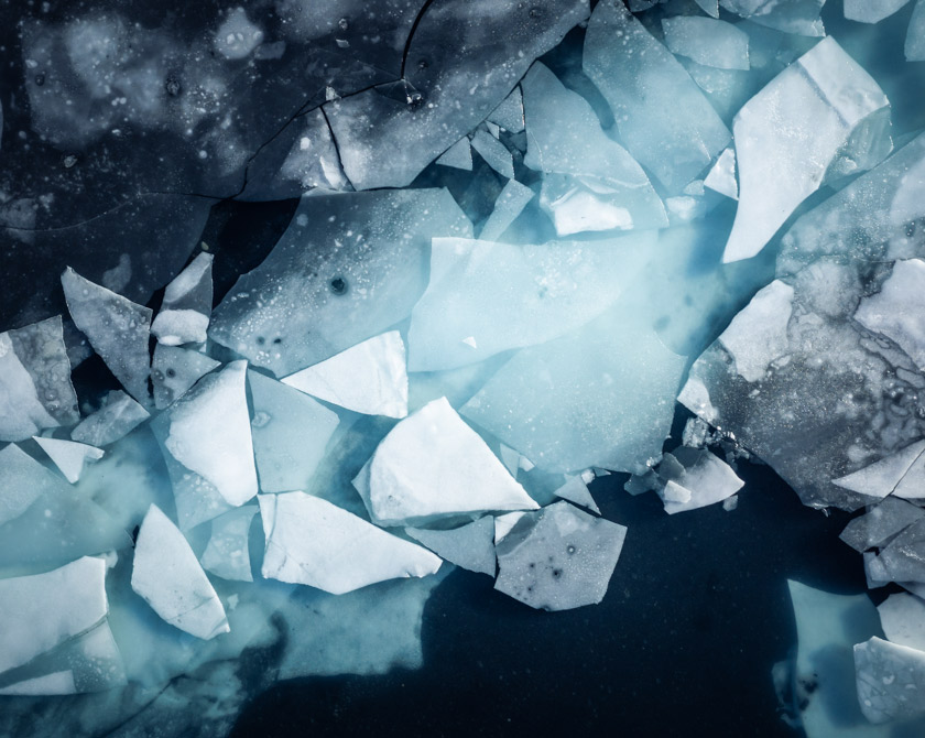 Aerial view of a thawing lake in Iceland with ice floes on the surface
