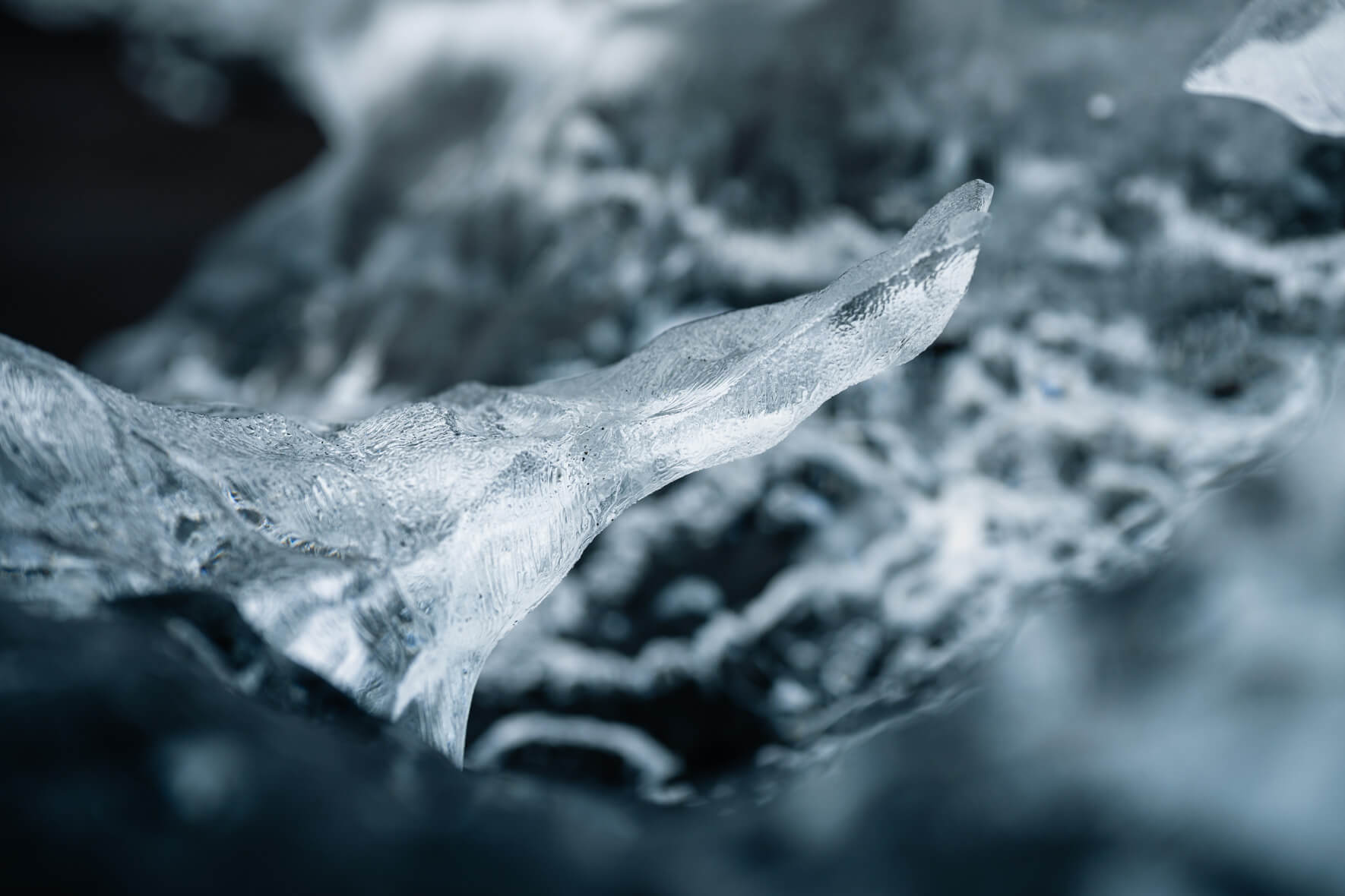 Macro view of glacial ice on black sand beach capturing fragile details
