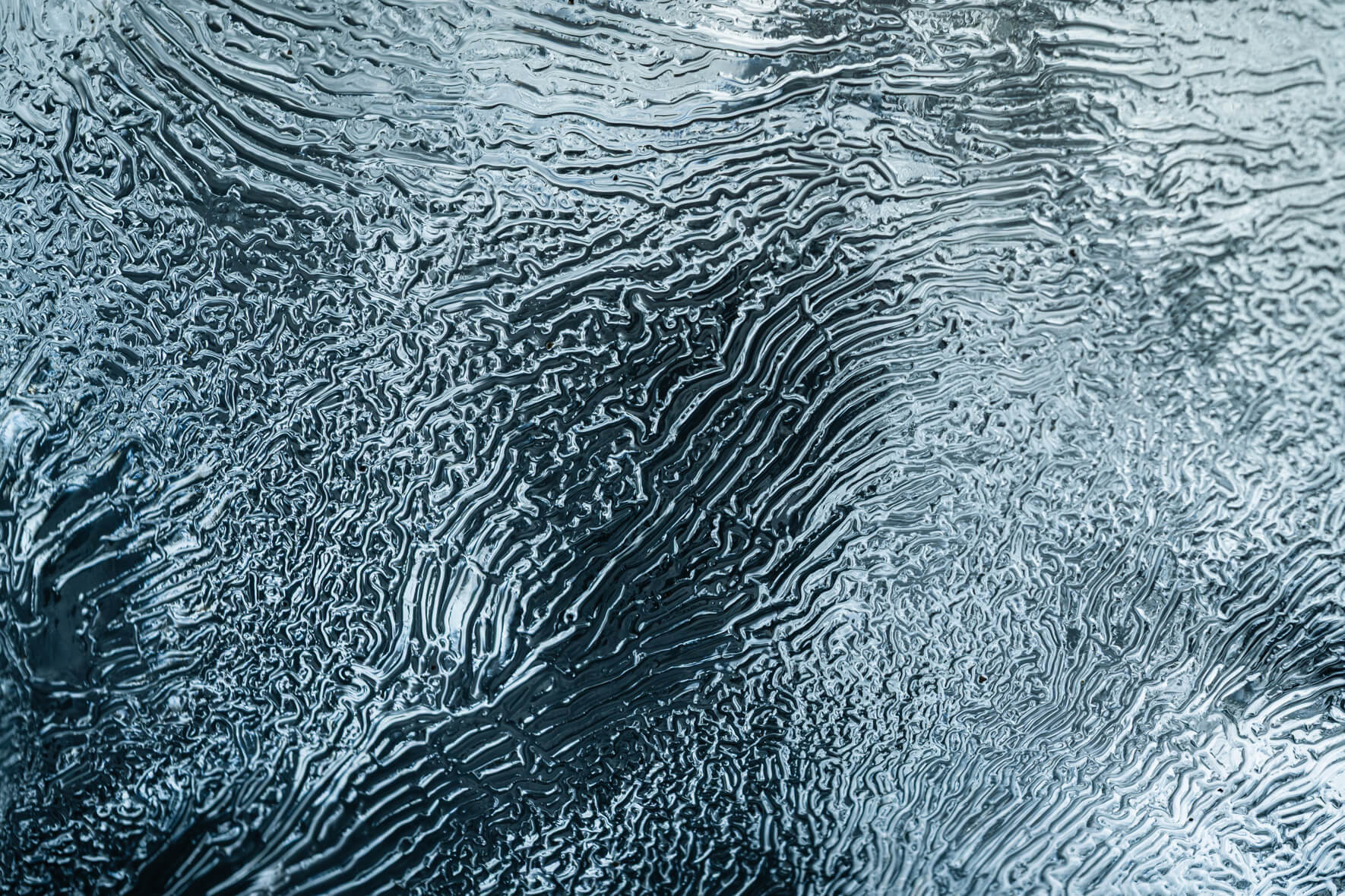 Macro of glacial ice revealing delicate channels on Diamond Beach in Iceland