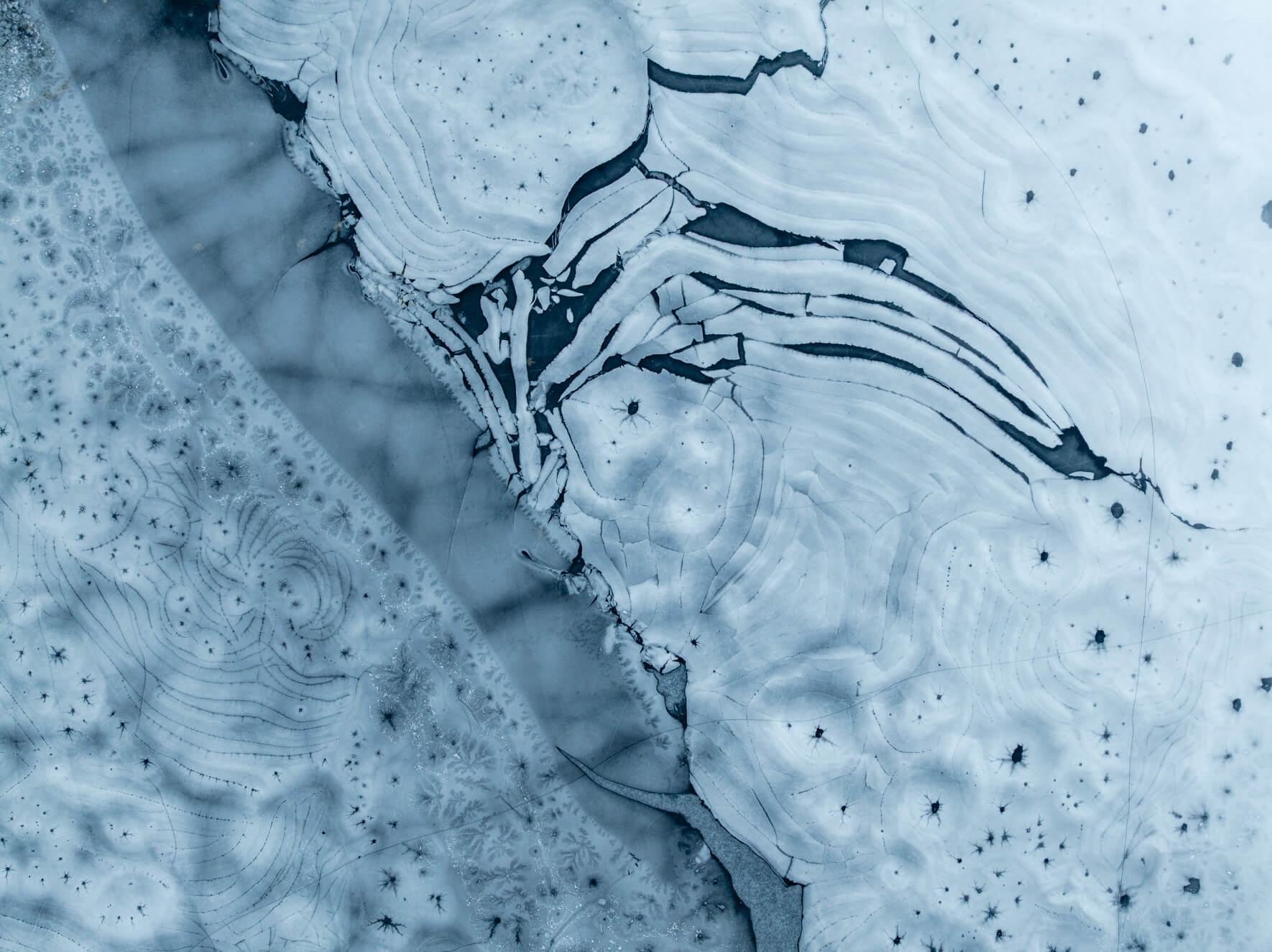 Frozen lake structure showing layered textures beneath translucent ice in Norway