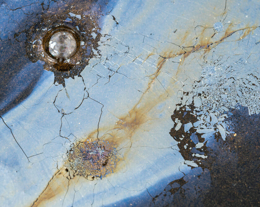 Aerial view of oxidized surface with vivid metallic colors formed by iron bacteria in Norway