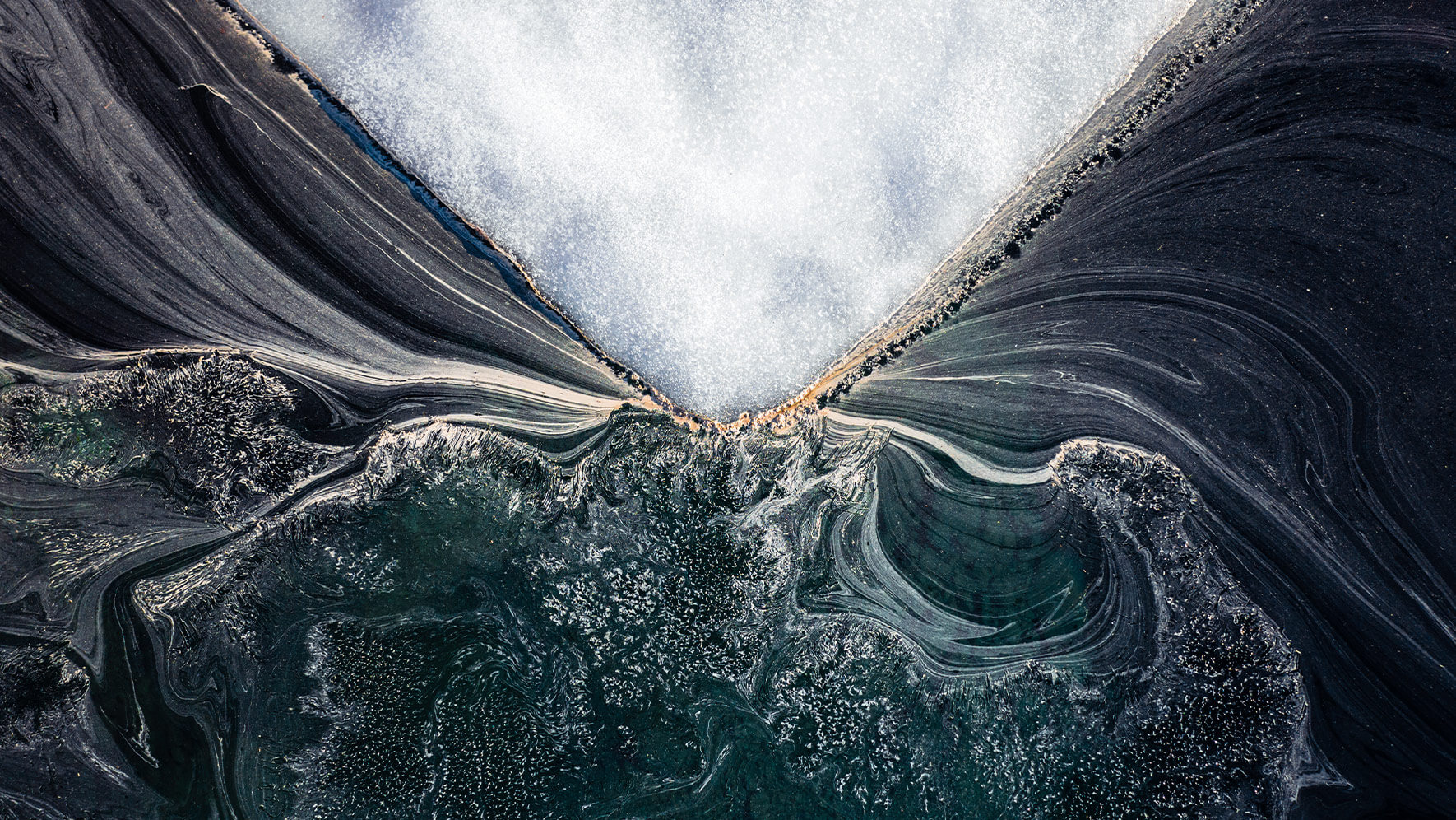 Aerial photograph of iceberg in mountain lake