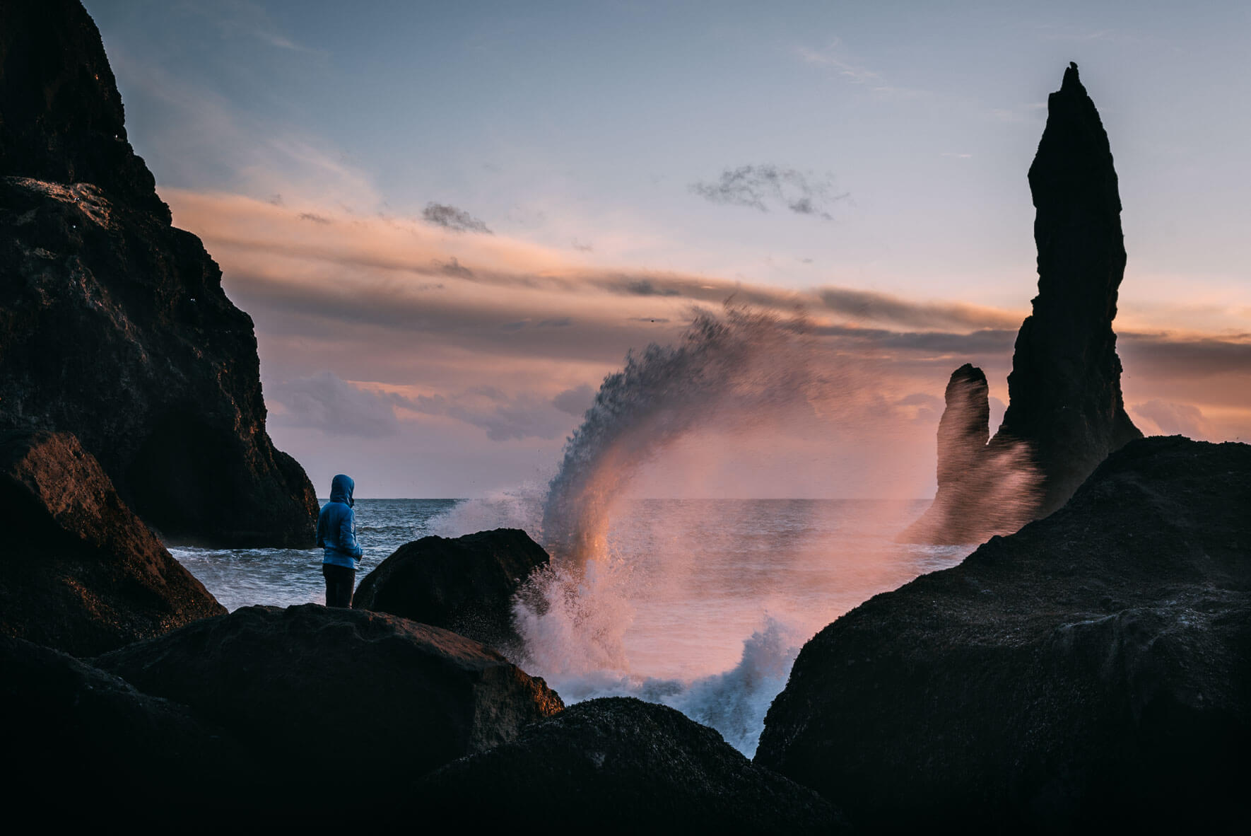Waves crashing on Reynisfjara beach with Reynisdrangar in the background