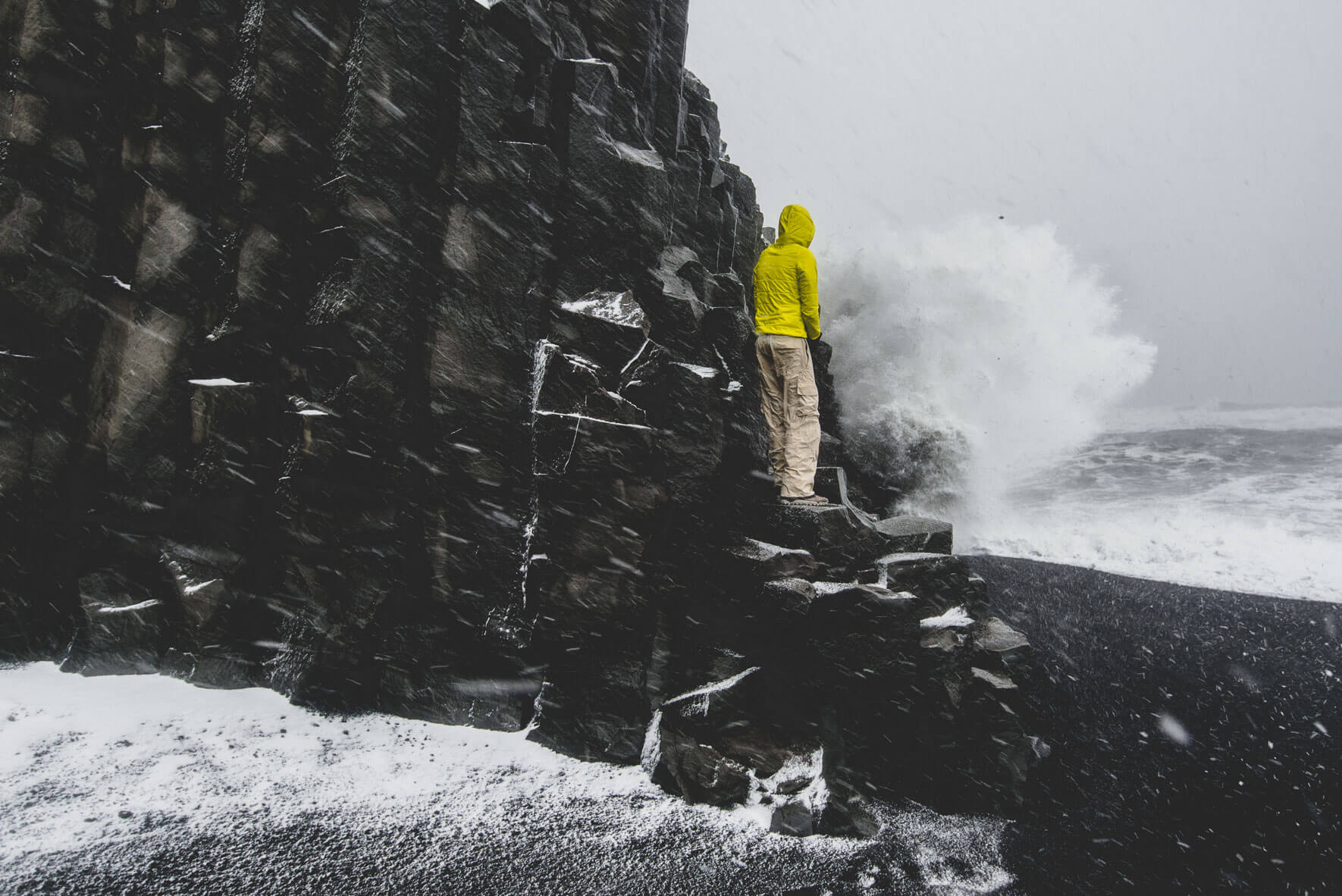 Waves crashing on basalt cliffs at Reynisfjara beach in Iceland