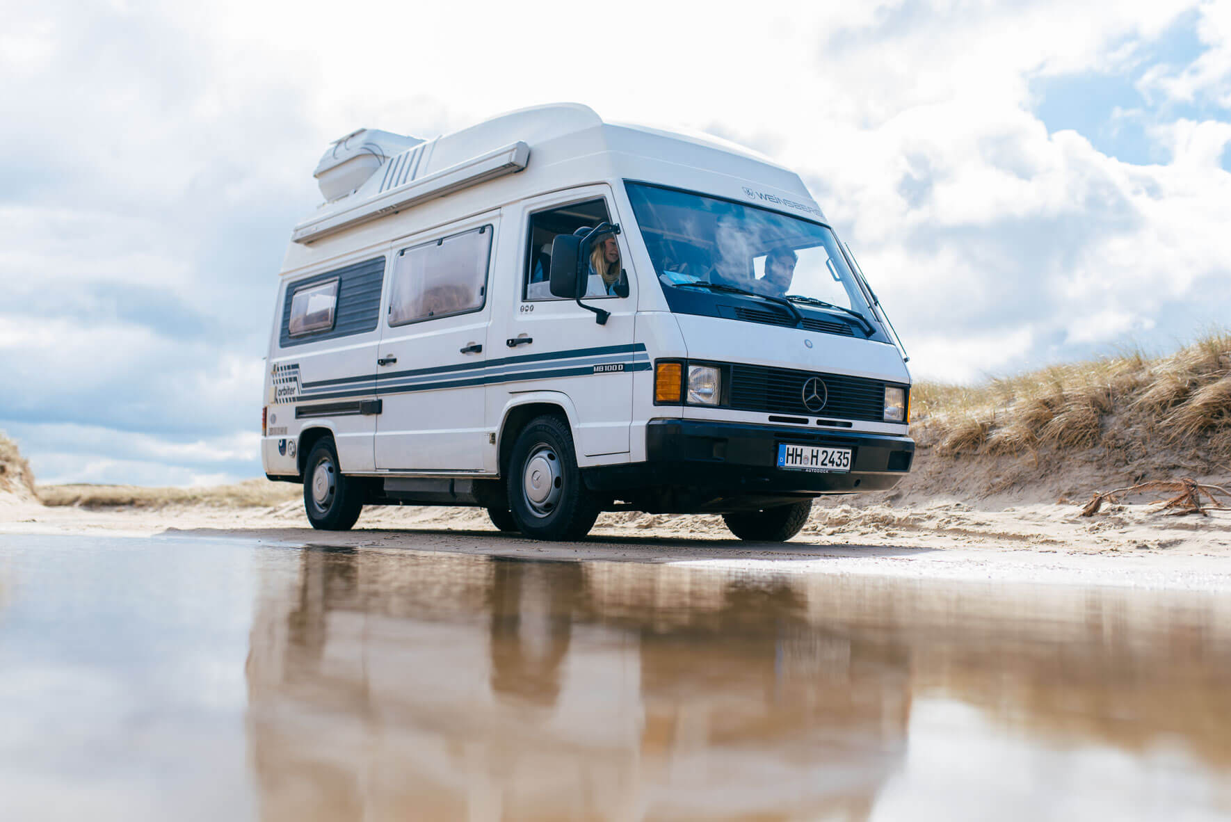Mercedes-Benz MB 100 camper van on a beach in Denmark
