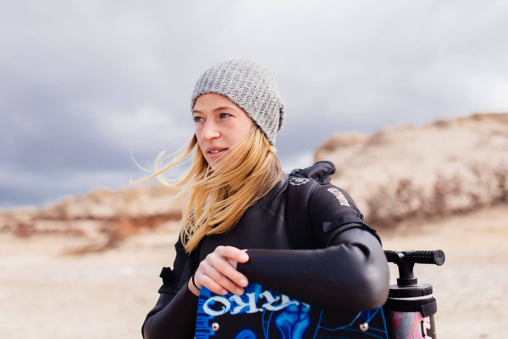 Woman with kite equipment on the beach
