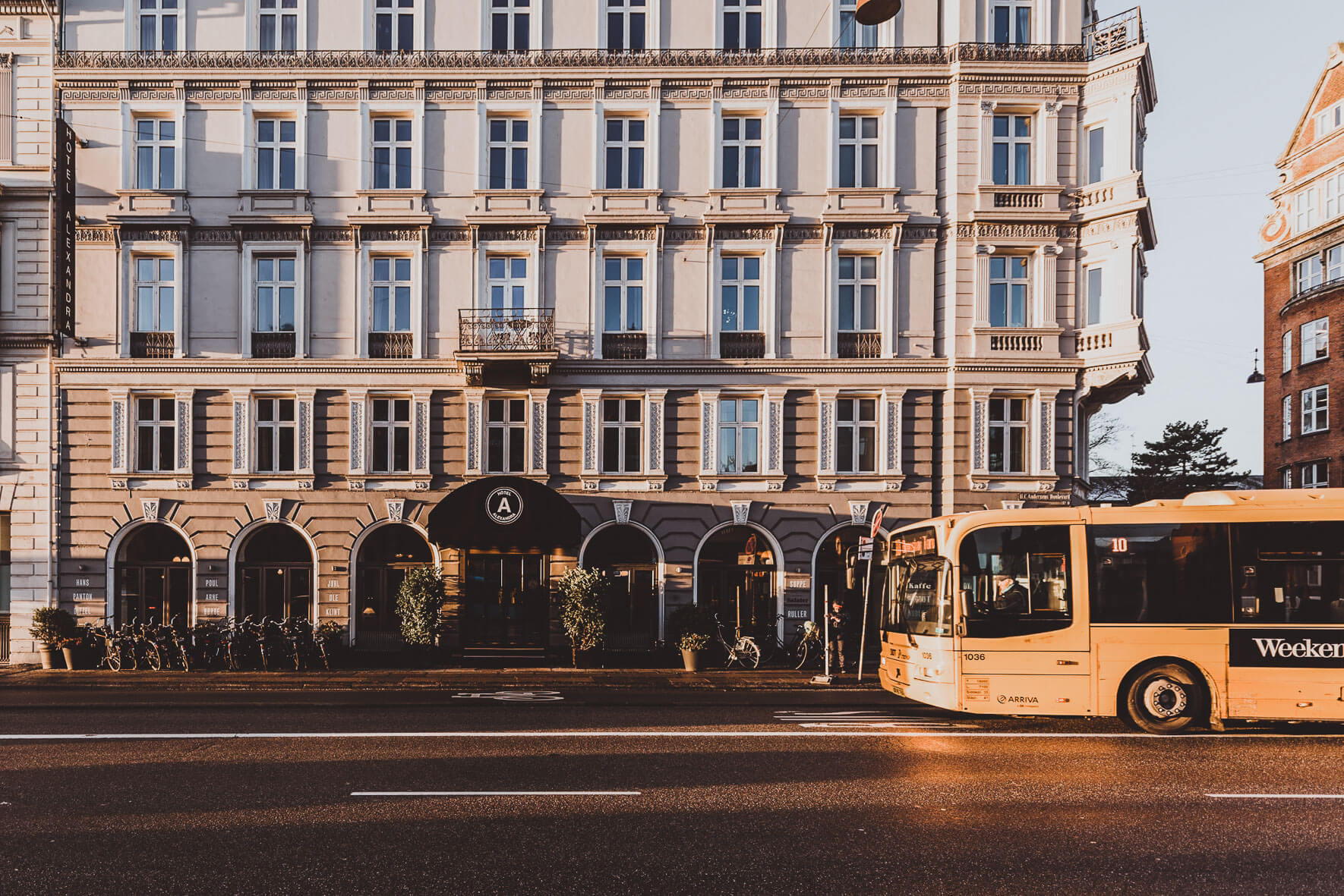 Hotel Alexandra in Copenhagen in the winter morning sun with yellow bus
