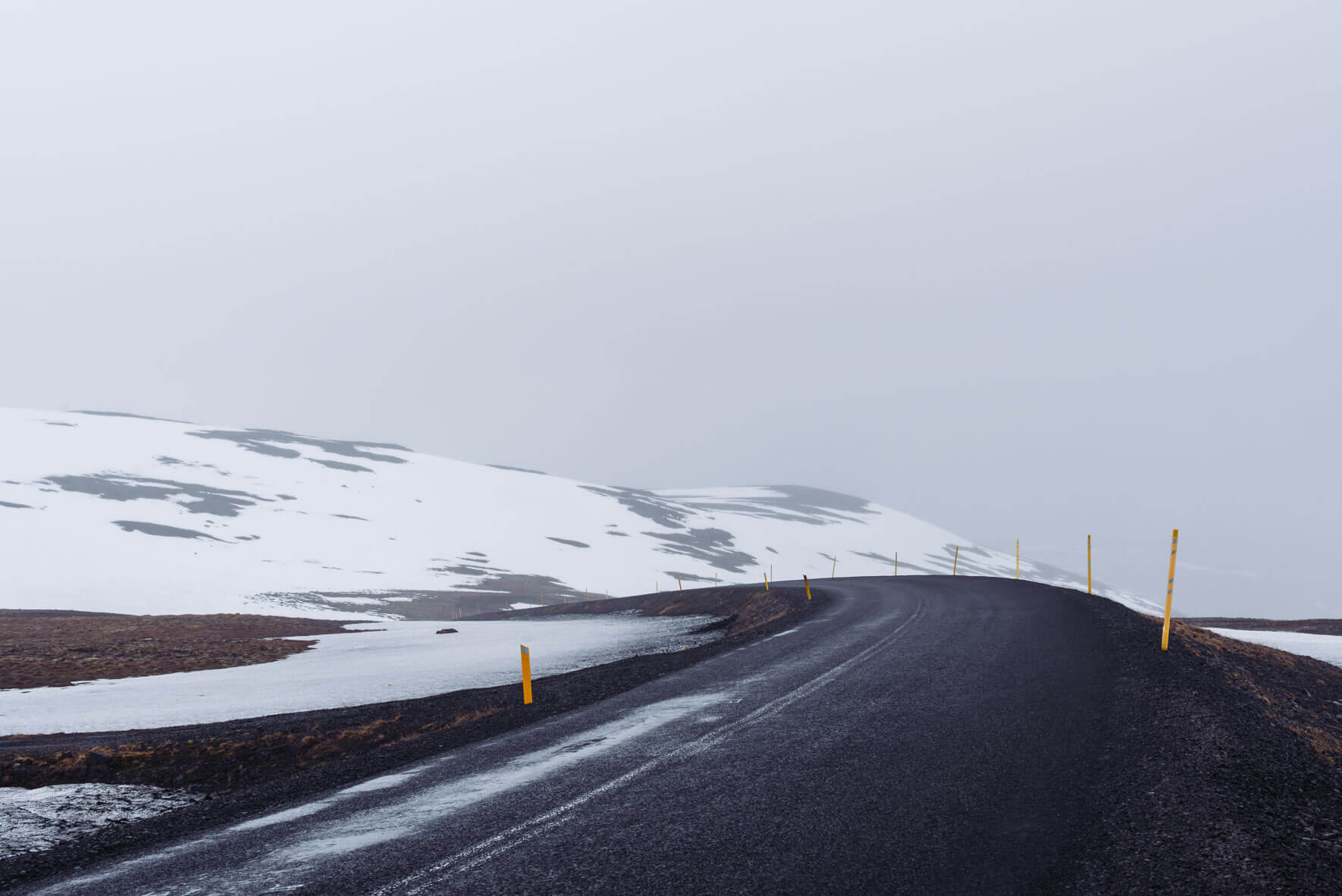 A road over the snowy mountains in the Westfjords of Iceland