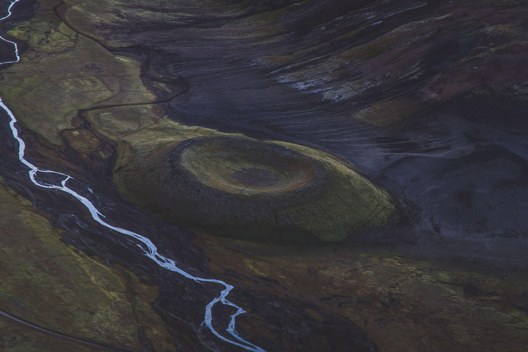 Aerial view of a volcano crater and river in the Highlands of Iceland