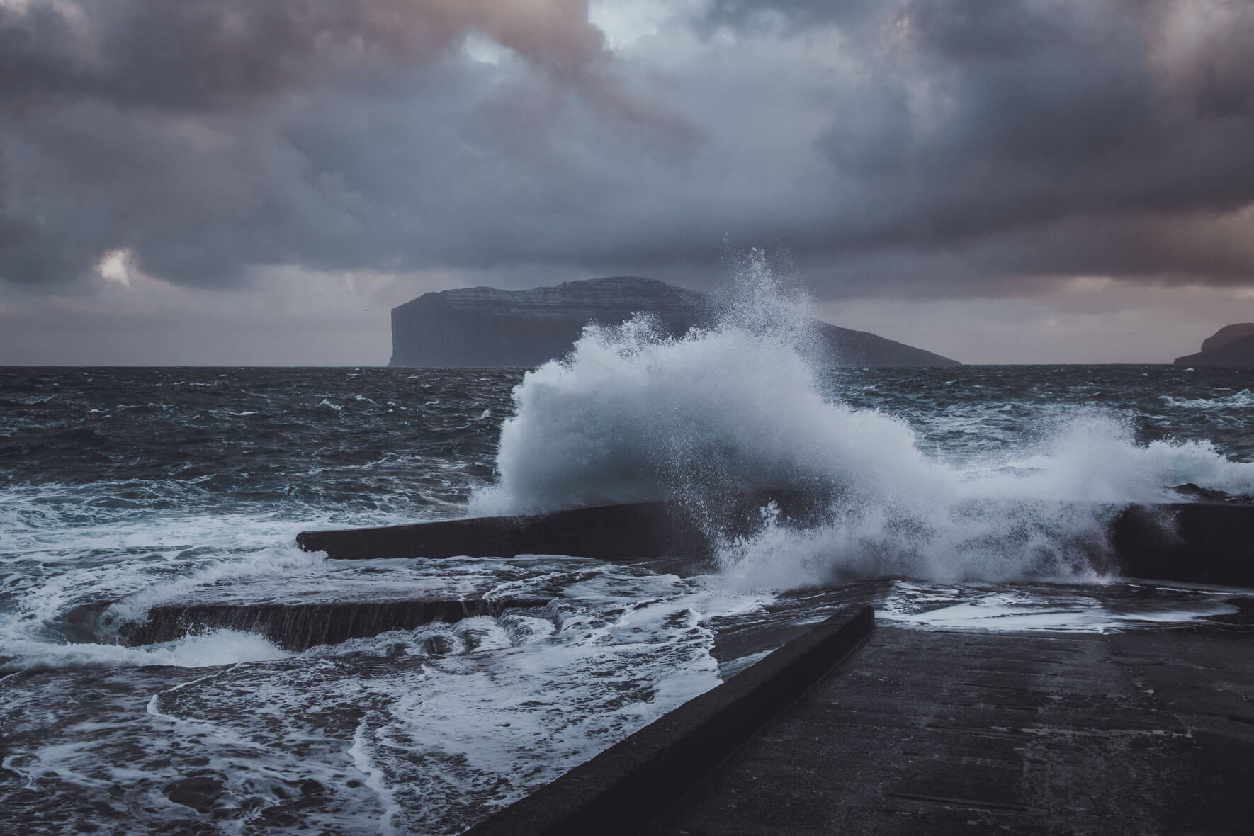 Big waves at the small harbor of Viðareiði on the Faroe Islands