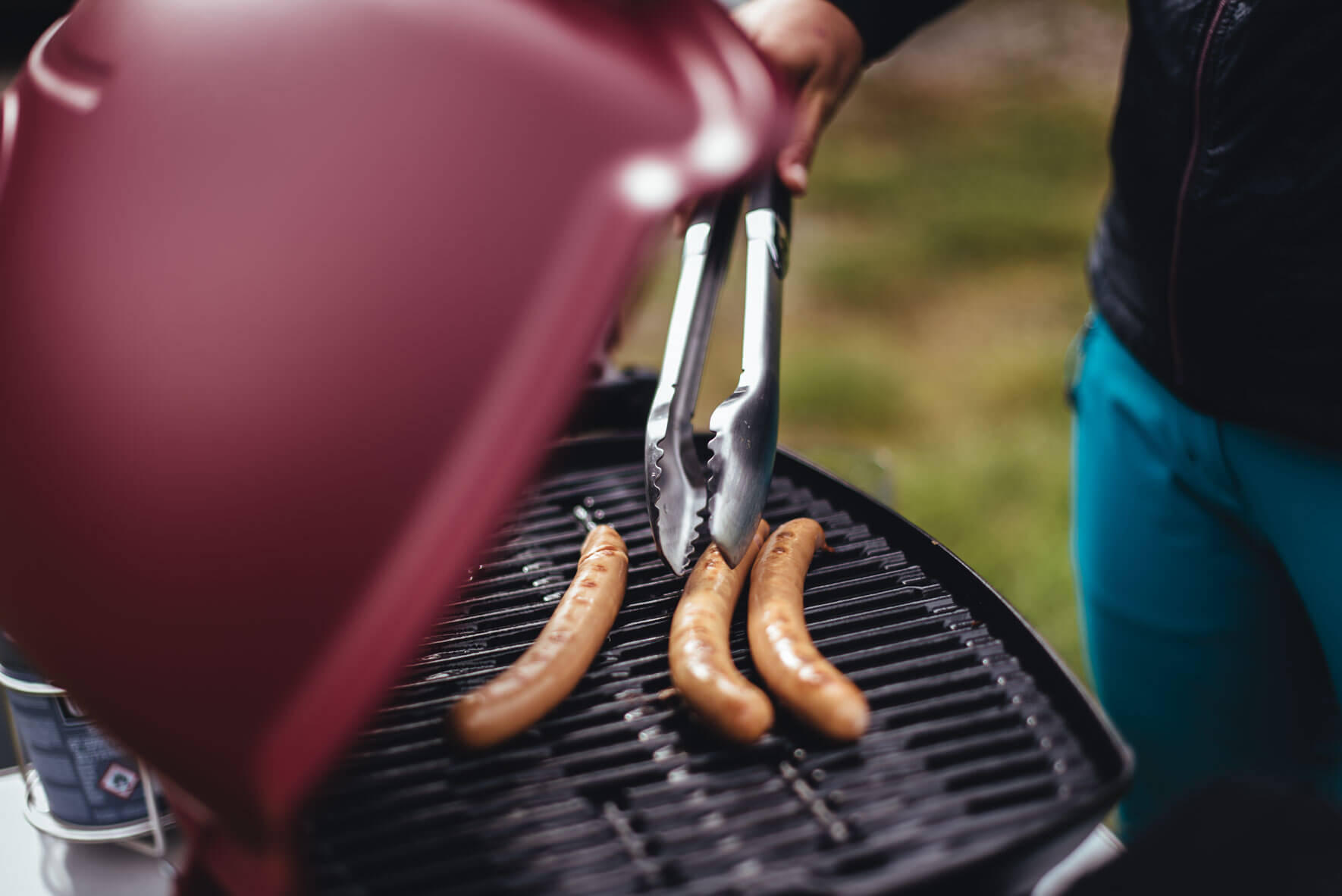Sausages on red Weber Q1200 grill